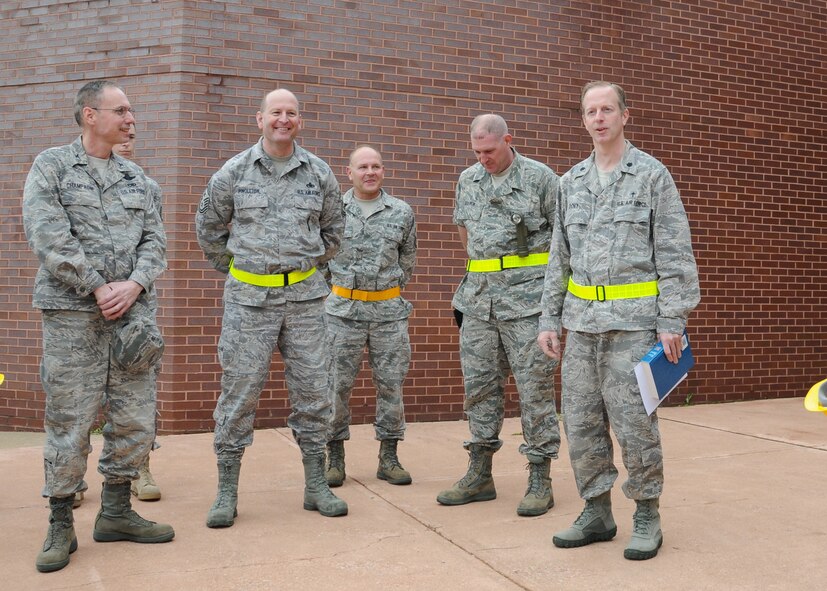 Chaplain Lt. Colonel Scott Doby (rightr), addresses members of the 131st Bomb Wing during an ecumenical service  in front of Headquarters Building 131, April 24.  A catagory EF2 tornado touched down at Lambert International Airport in Saint Loius and swept through the south side of the Lambert Air National Guard Base.  No injuries were reported, but the base suffered extensive damage to many of its structures..  (Photo by Master Sgt. Mary-Dale Amison)