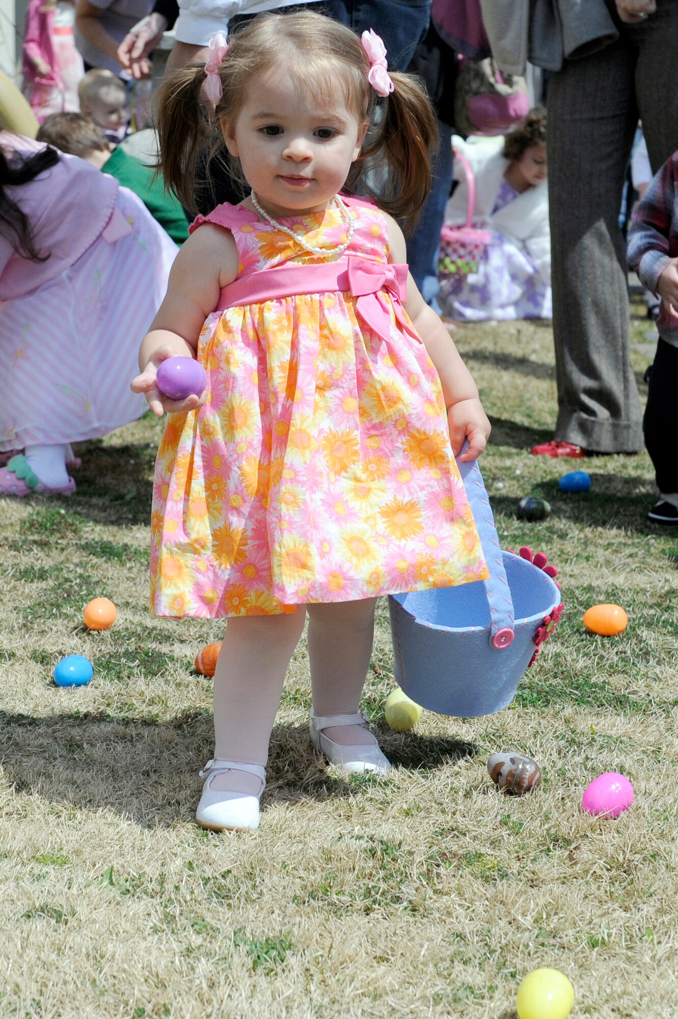 MISAWA AIR BASE, Japan -- Eighteen-month-old Hannah Hughett, daughter of Capt. Eric Hughett, 14th Fighter Squadron, sets her eyes on her next egg 24 April. More than 100 man-hours were put into filling approximately 4,000 empty eggs with candy and toys by the collocated club staff.(U.S. Air Force photo by Staff Sgt. Marie Brown\Released)