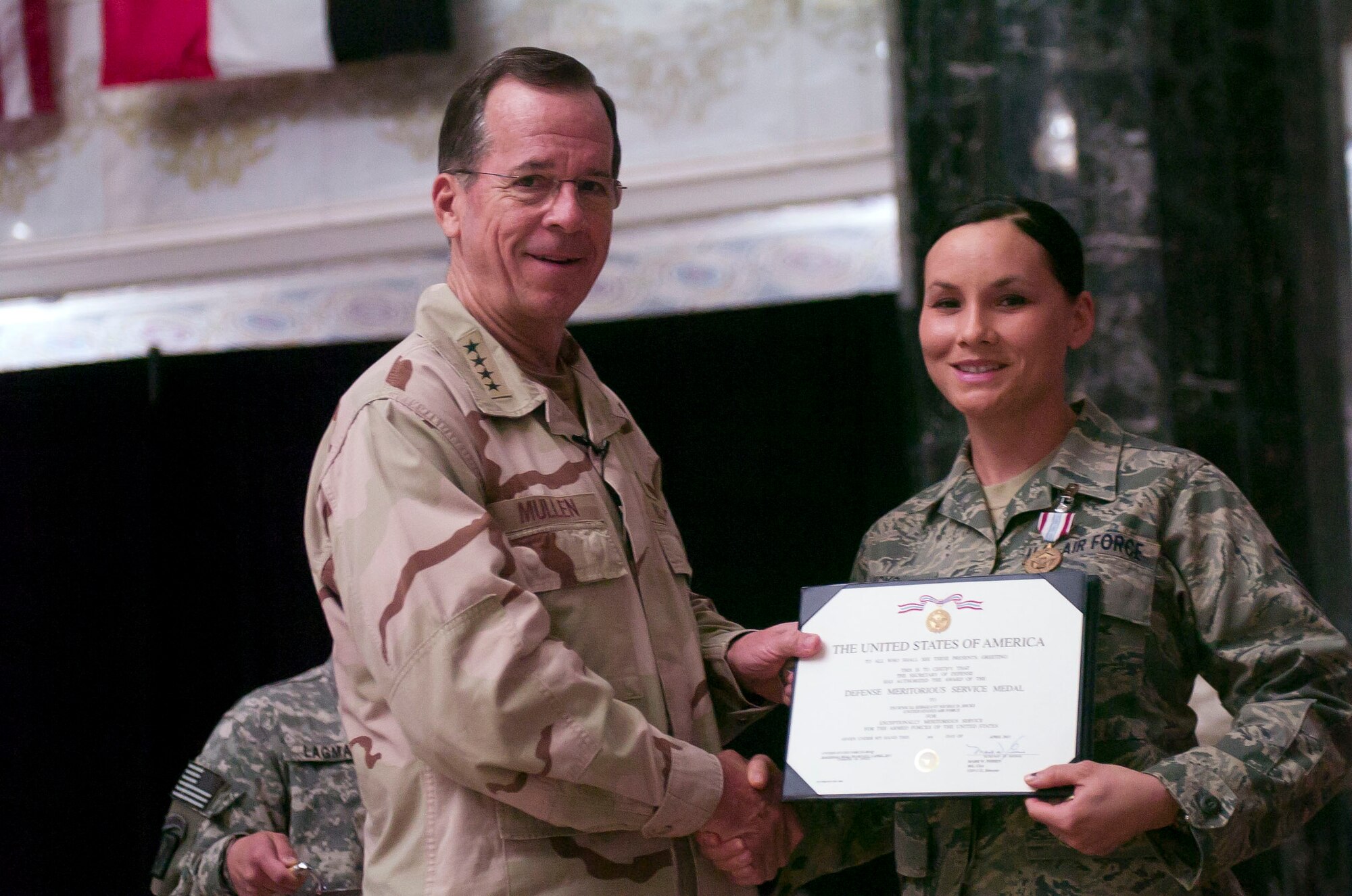 The Chairman of the Joint Chiefs of Staff, Admiral Mike Mullen awarded Tech. Sgt. Nicole Hicks, U.S. Forces-Iraq J2-Joint Intelligence executive NCO in charge, the Defense Meritorious Service Medal at an award ceremony Al Faw Palace, Camp Victory, Baghdad, April 22, 2011. (U.S. Forces-Iraq courtesy photo)