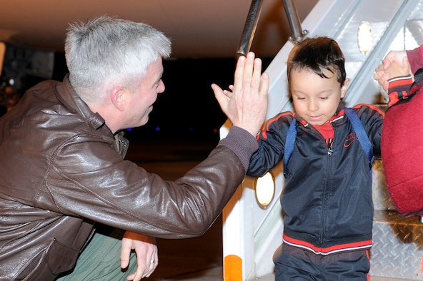 MISAWA AIR BASE, Japan -- Col. Al Wimmer, 35 Fighter Wing Vice Commander, gives four-year-old Mark Gillett, son of Staff Sgt. Mark Gillett, 35th Communications Squadron, a "high five" as he steps off the plane 22 April. Mark and his mother were among more than 1,300 dependents from Misawa AB who participated in the Defense Department approved voluntary departure for families affected by the March 11 earthquake and tsunami. (U.S. Air Force photo/Staff Sgt. Marie Brown)