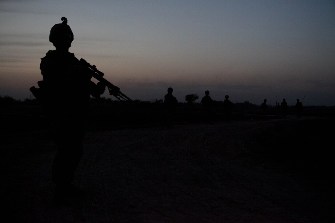 Marines with one of the three Combined Anti-Armor Teams assigned to 3rd Battalion, 4th Marine Regiment, patrol a dirt road late in the evening. They are taking advantage of the harvest time to supply the Marines with food, water, hygiene equipment, power generators and even mail. ::r::::n::::r::::n::::r::::n::