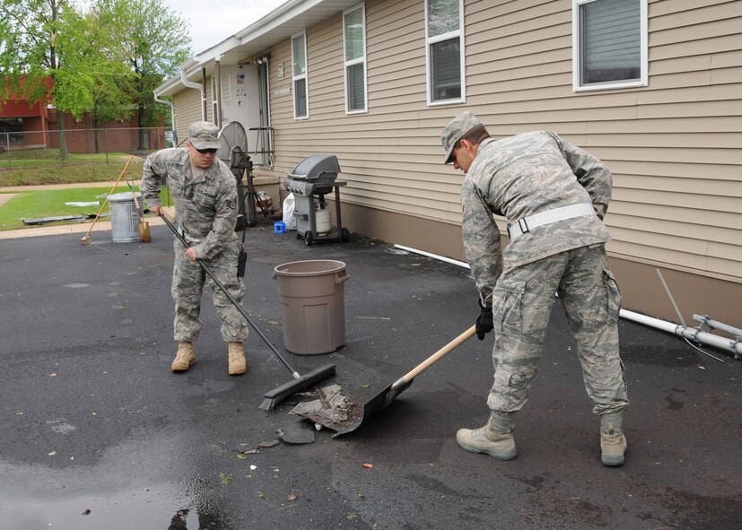 Members of the 131st Bomb Wing clean up around their building, April 25.  A category EF2 tornado hit Lambert-Saint Louis International Airport and swept across the 131st Bomb Wing Missouri Air National Guard Base, April 22.  No injuries were reported to Air National Guard personnel, but there was widespread damage across the south-side of the base.  Cleanup efforts at the base are ungoing. (Photo by Master Sgt. Mary-Dale Amison)