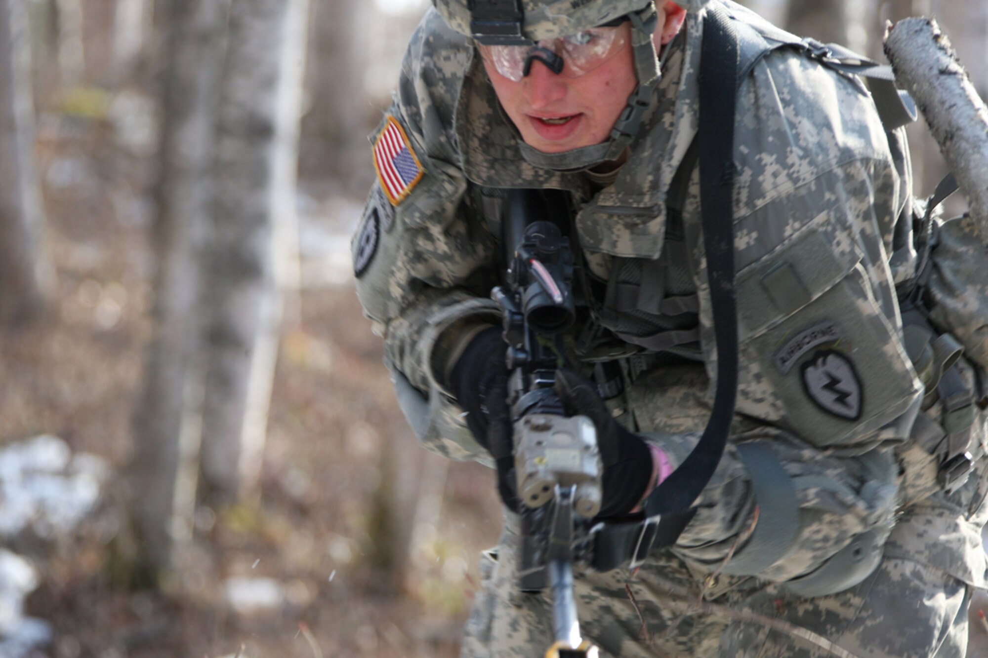 Army Spc. Christopher Weber, A Co, 1-501st Inf Bn (Abn), performs movement under direct fire during the patrol lane portion of the EIB testing.  Weber moved 50 meters toward the objective within five minutes using the low crawl, the high crawl, and the rush across varied terrain. (U.S. Air Force photo/Percy Jones)
