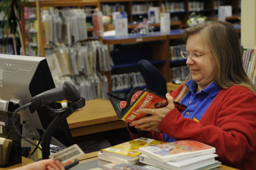 Circulation Clerk Catherine Lanham checks out several books and movies for a
family at the Base Library located on Barksdale Air Force Base, La., April
25.  The library has more than 40,000 books and 1,200 movies available to
check-out for all base personnel, their dependants and local retirees. The
library is open Monday through Thursday from 10 a.m. to 8 p.m., Friday from
10 a.m. to 6 p.m., Saturday from 11 a.m. to 6 a.m. and is closed on Sundays
and holidays.  (U.S. Air Force photo/2nd Lieutenant Victoria
Lalich)(Released)  