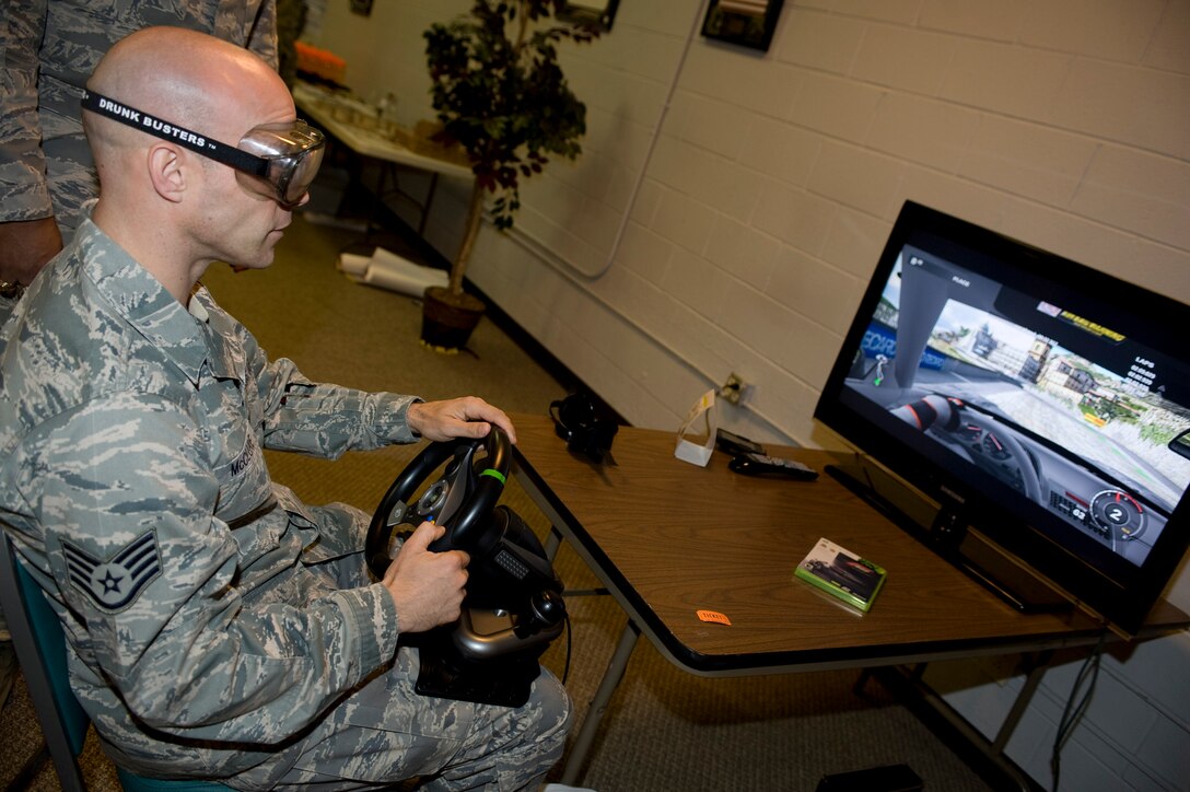 Staff Sgt Harry McClore, 735th Supply Chain Operations Squadron stock control journeyman, operates the Drunk Buster drunk driving simulator at Langley Air Force Base, Va., April 22, 2011.  Military Pathways and The Alcohol and Drug Abuse Prevention and Treatment program held an alcohol awareness event to inform Airman about alcohol abuse and the effects it has on the community. (U.S. Air Force photo by Senior Airman Brian Ybarbo/Released)