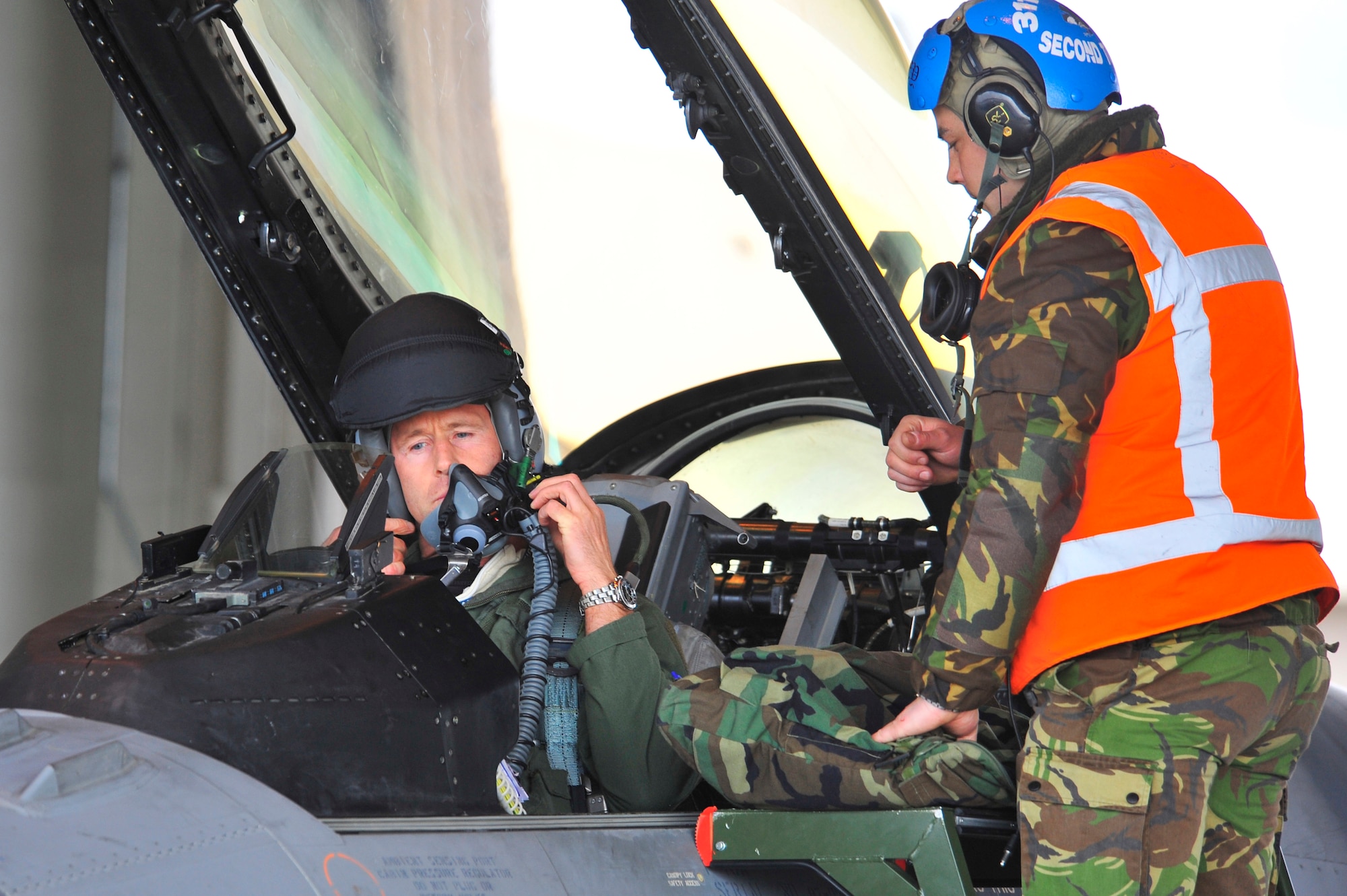 A Royal Netherlands air force F-16A pilot and crew chief prepare for a sortie during RED FLAG-Alaska, April 21, 2011. RF-A provides unique opportunities to integrate various forces into joint, coalition and bilateral training from simulated forward operating bases. (U.S. Air Force photo/Staff Sgt. Christopher Boitz)