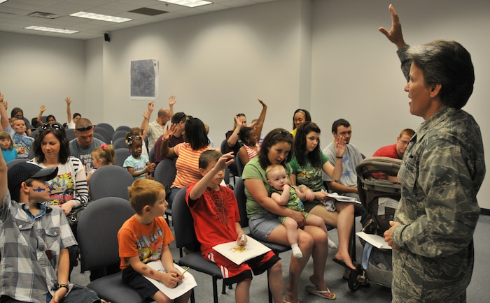 Col. Martha Meeker speaks to a room full of children and their parents April 23, about their important mission, code-named ?Treasures of Monaco,? during a children?s deployment line at Joint Base Charleston - Air Base. The children?s mission was to send a wedding present, a royal Easter egg, to the soon-to-be newlyweds Prince William Louis of Wales and Kate Middleton. Col. Meeker is the Joint Base Charleston commander. (U.S. Air Force photo /Airman 1st Class Jared Trimarchi)
