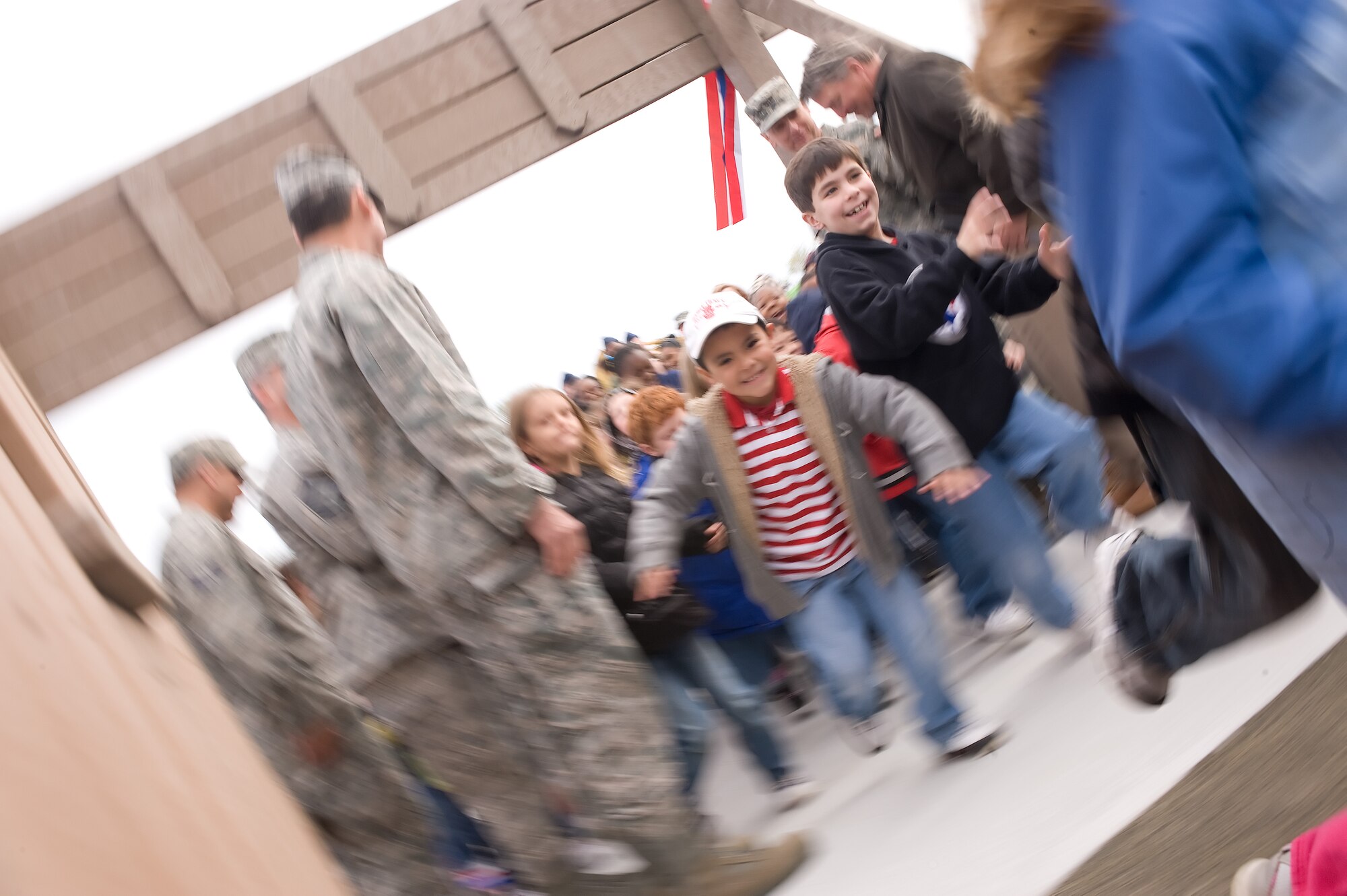 Children rush into the newly opened Dover Aux Field at Liberty Park after Gen. Raymond Johns, Air Mobility Command commander, cuts the ribbon at the dedication ceremony April 22, 2011, at Dover Air Force Base, Del. (U.S. Air Force photo by Steve Kotecki)