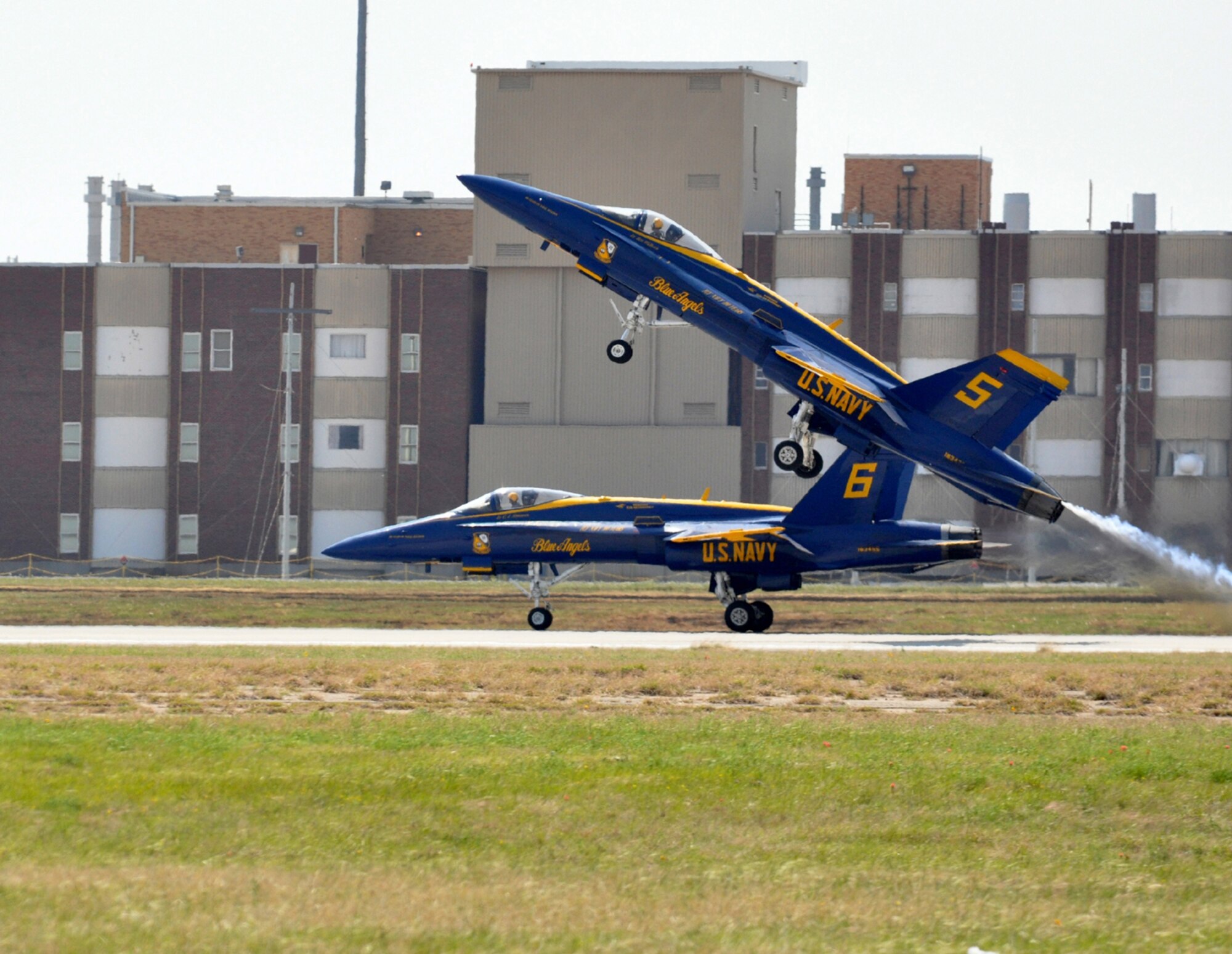 Blue Angels' solo performers, Navy Lt. Ben Walborn (in aircraft 5) and Navy Lt. C.J. Simonsen, take off April 17 in two of the team's F-18 Hornets during the 2011 Air Power Expo at Naval Air Station Fort Worth Joint Reserve Base, Texas.  (U.S. Air Force photo/Lt. Col. David Kurle)