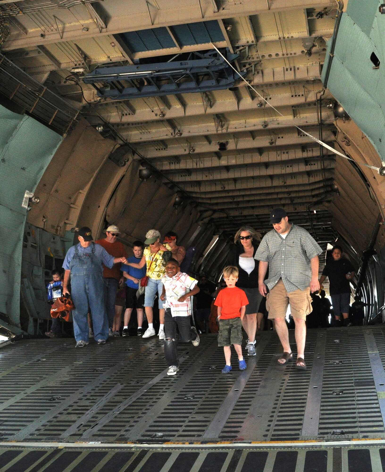 Visitors to the 2011 Air Power Expo walk down the aft ramp of a C-5 transport during at Naval Air Station Fort Worth Joint Reserve Base, Texas, April 16.  Officials expected more than 100,000 people to visit the base each day of the two-day open house.  (U.S. Air Force photo/Staff Sgt. Chris Bolen)