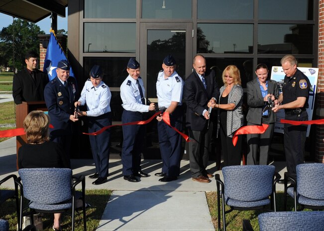 Brig. Gen. Kevin Jacobsen (second from left), Col. Martha Meeker (third from left) and invited guests cut the ribbon at the Air Force Office of Special Investigations grand opening ceremony, April 25, 2011 on Joint Base Charleston, S.C. Construction on the new AFOSI building began in August 2009 and was completed in October 2010. The new building boasts state-of-the-art technology and additional space, allowing special agents a much improved work environment. General Jacobson is the commander of the AFOSI and Col. Meeker is the 628th Air Base Wing. (U.S. Air Force photo/Senior Airman Timothy Taylor)