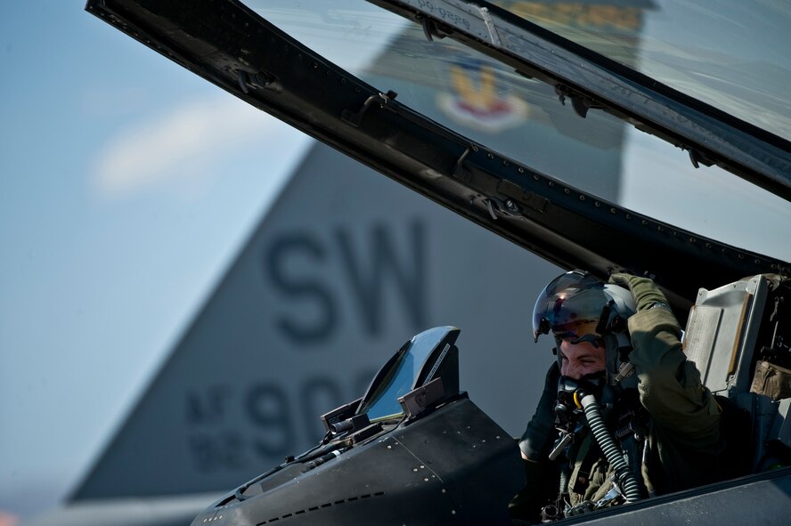 Capt. Jeremy Nolting, 79th Fighter Squadron pilot, puts on his helmet in the cockpit of a F-16 Fighting Falcon before departing on a training mission during exercise Green Flag West 11-6, April 20, 2011. (U.S. Air Force photo by Tech. Sgt. Michael R. Holzworth) 

