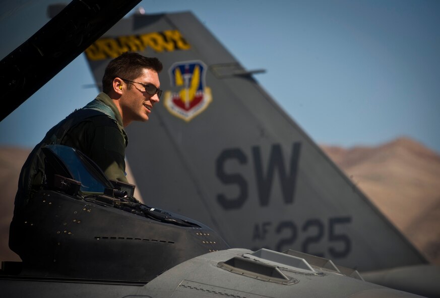 Capt. Jeremy Nolting, 79th Fighter Squadron F-16 pilot, sits on the edge of the cockpit of a F-16 Fighting Falcon during exercise Green Flag West 11-6, April 20, 2011. Green Flag West replicates irregular warfare conditions currently found in Southwest Asia. Aircrews, work closely with Air Force joint terminal attack controllers. (U.S. Air Force photo by Senior Airman Brett Clashman) 

