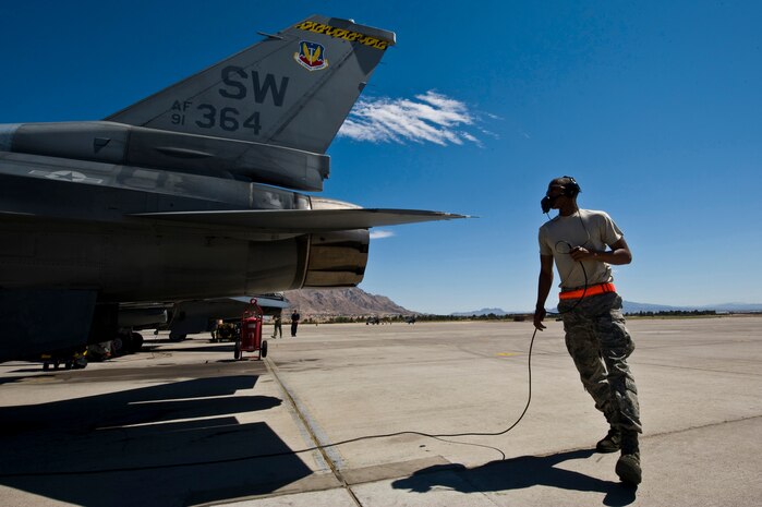 NELLIS AIR FORCE BASE, Nev. -- Airman 1st Class Stephen Long, crew chief, 20th Aircraft Maintenance Squadron, Shaw Air Force Base, S.C., walks around a F-16 Fighting Falcon during Green Flag West 11-6. April 20. Green Flag West replicates irregular warfare conditions currently found in Southwest Asia. Aircrews, work closely with Air Force joint terminal attack controllers. Pilots train for a mission such as close air support, and aerial reconnaissance. (U.S. Air Force photo by Senior Airman Brett Clashman)
