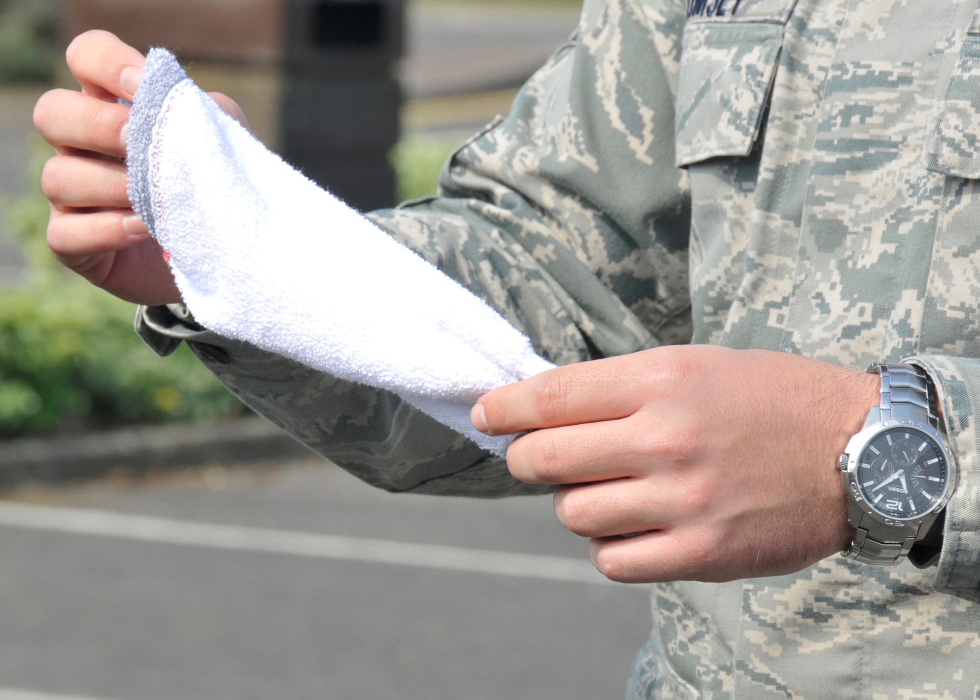 ROYAL AIR FORCE LAKENHEATH, England - Airman 1st Class Brooks Kimsey, 48th Contracting Squadron contract administrator, checks a sock for cleanliness during the Dirty Sock Competition for Earth Week at Defender Park on April 20, 2011. A vehicle idles for two minutes while a sock is connected to the exhaust pipe to test the cleanliness of the vehicle. The winner received a voucher for a free car wash. (U.S. Air Force photo/ Senior Airman Tiffany M. Deuel)