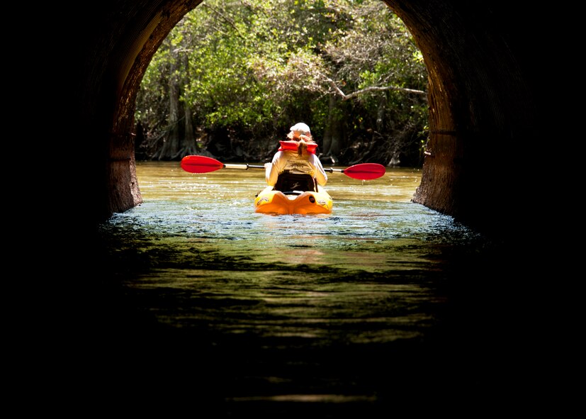 Angel McCurdy passes underneath a bridge while drifting down Turkey Creek deep within the Eglin reservation April 21.   The second annual kayak tour, part of four days of trips, took 10 people down Turkey Creek deep within the Eglin range. The scenic tour showed off Eglin’s unique wild and plant life. The tour closed out Eglin’s week-long Earth Day celebration.  The kayaks were donated by Eglin's Outdoor Recreation for each day of the trip. (U.S. Air Force photo/Samuel King Jr.)

