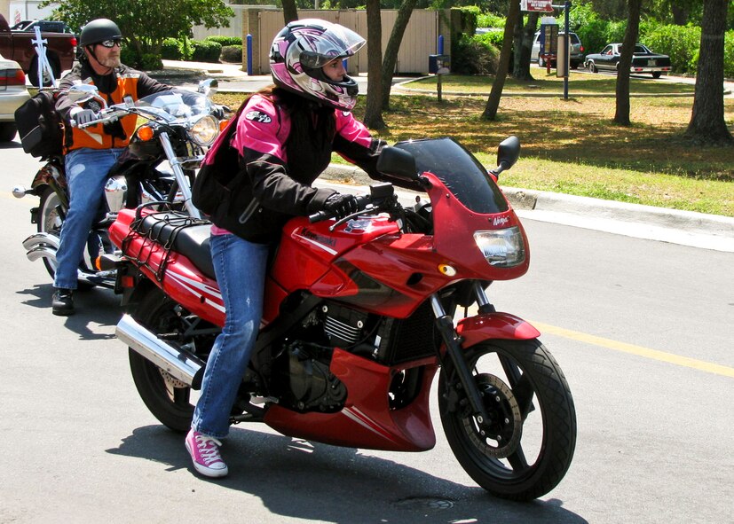 A rider maneuvers her bike through the base exchange parking lot after Eglin’s Motorcycle Safety Day event, April 21.  The event brought out more than 600 riders to participate in safety discussions, a riding skills course and group ride. (U.S. Air Force photo/Irene Freiberg)