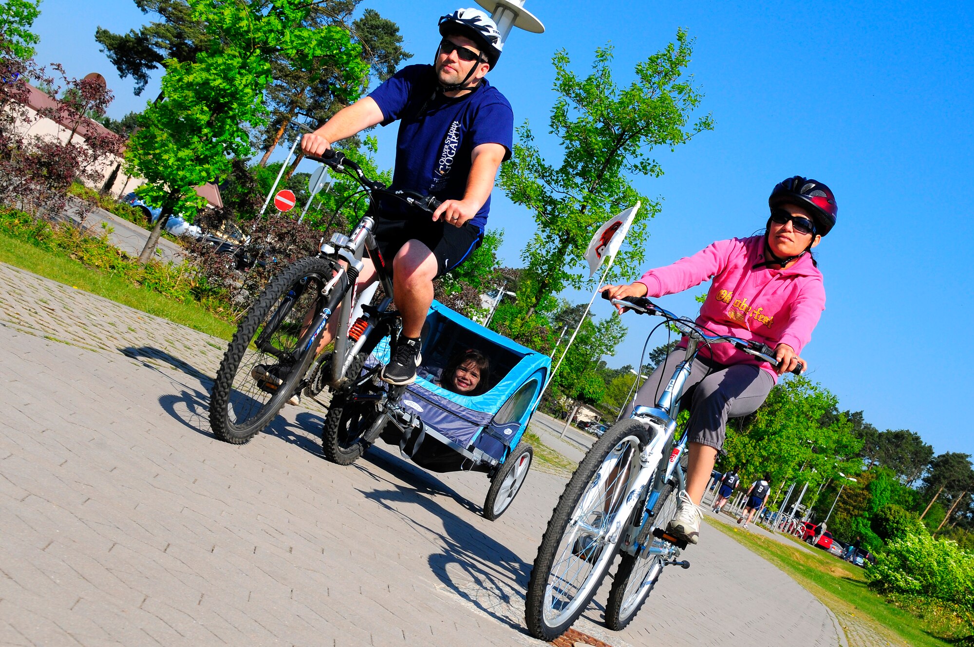 U.S. Air Force Capt. Jeremy Sheppard, North Atlantic Treaty Organization headquarters, rides with his wife and daughter, Mandy and Aubrey Sheppard, Ramstein Air Base, Germany, April 25, 2011. The month of April is Fitness Awareness Month which promotes a healthy lifestyle and recreational and fitness outlets. (U.S. Air Force Photo by Airman 1st Class Brea Miller) 