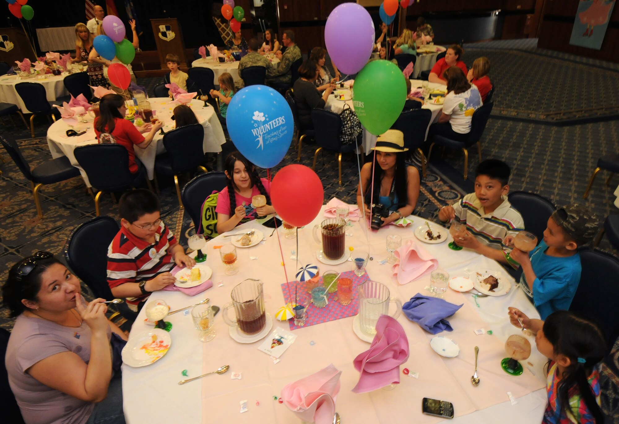 SPANGDAHLEM AIR BASE, Germany – Volunteers and children eat ice cream during a 52nd Fighter Wing volunteer recognition ceremony here at Club Eifel April 21. The ceremony was combined with an ice-cream social to thank wing volunteers for their efforts throughout the year. (U.S. Air Force photo/Staff Sgt. Benjamin Wilson)