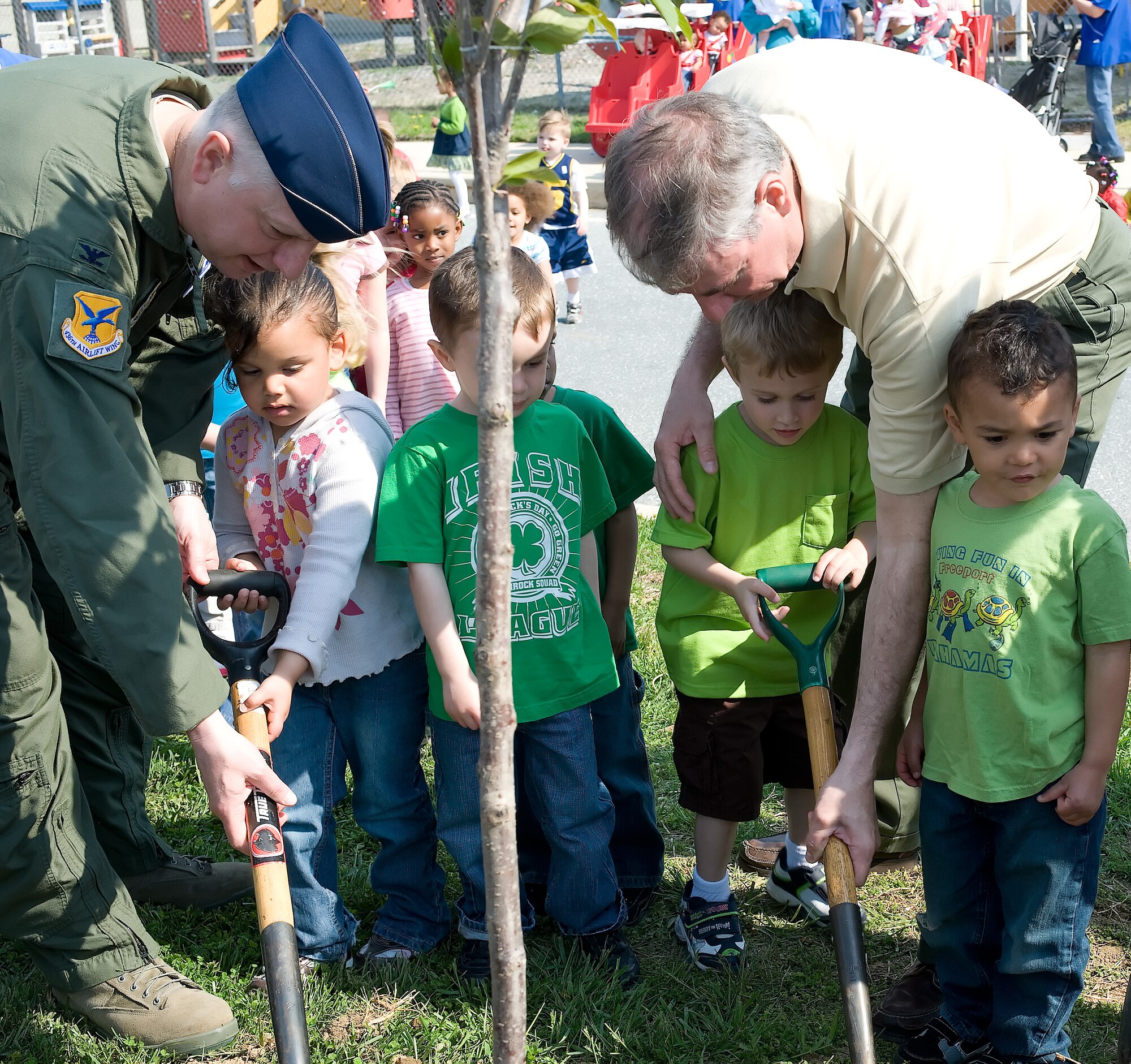 Col. Mark Camerer and Delaware State Forester Mike Valenti help children from the Child Development Center plant a tree at Dover Air Force Base, Del. on April 20, 2011. The tree was planted in honor of Earth Day. Mr. Valenti wanted the children to learn “Trees make for a healthier environment.” (U.S. Air Force photo by Adrian Rowan)