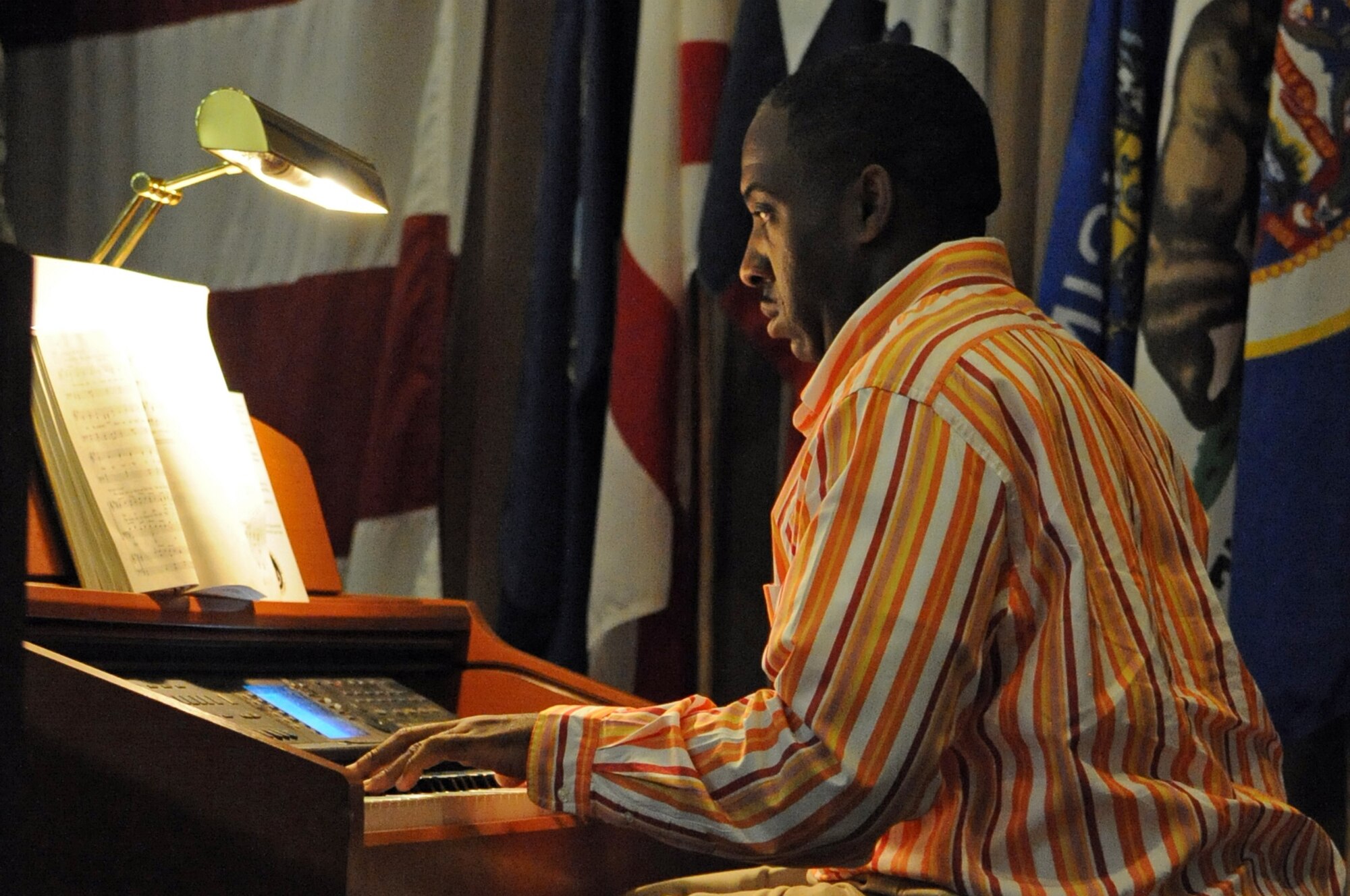 A pianist from the River's Edge and Barksdale Combined Gospel Inspirational Choir plays a piano during the National Prayer Luncheon held on Barksdale Air Force Base, La., April 20. The luncheon was held as a reminder of our nation's spiritual background. The Chief of Air Force Chaplains Maj. Gen. Cecil Richardson was the guest speaker for the event. The chaplain used a few of his own life experiences as an example to inspire Airmen. (U.S. Air Force photo/Airman 1st Class Micaiah Anthony)(RELEASED)