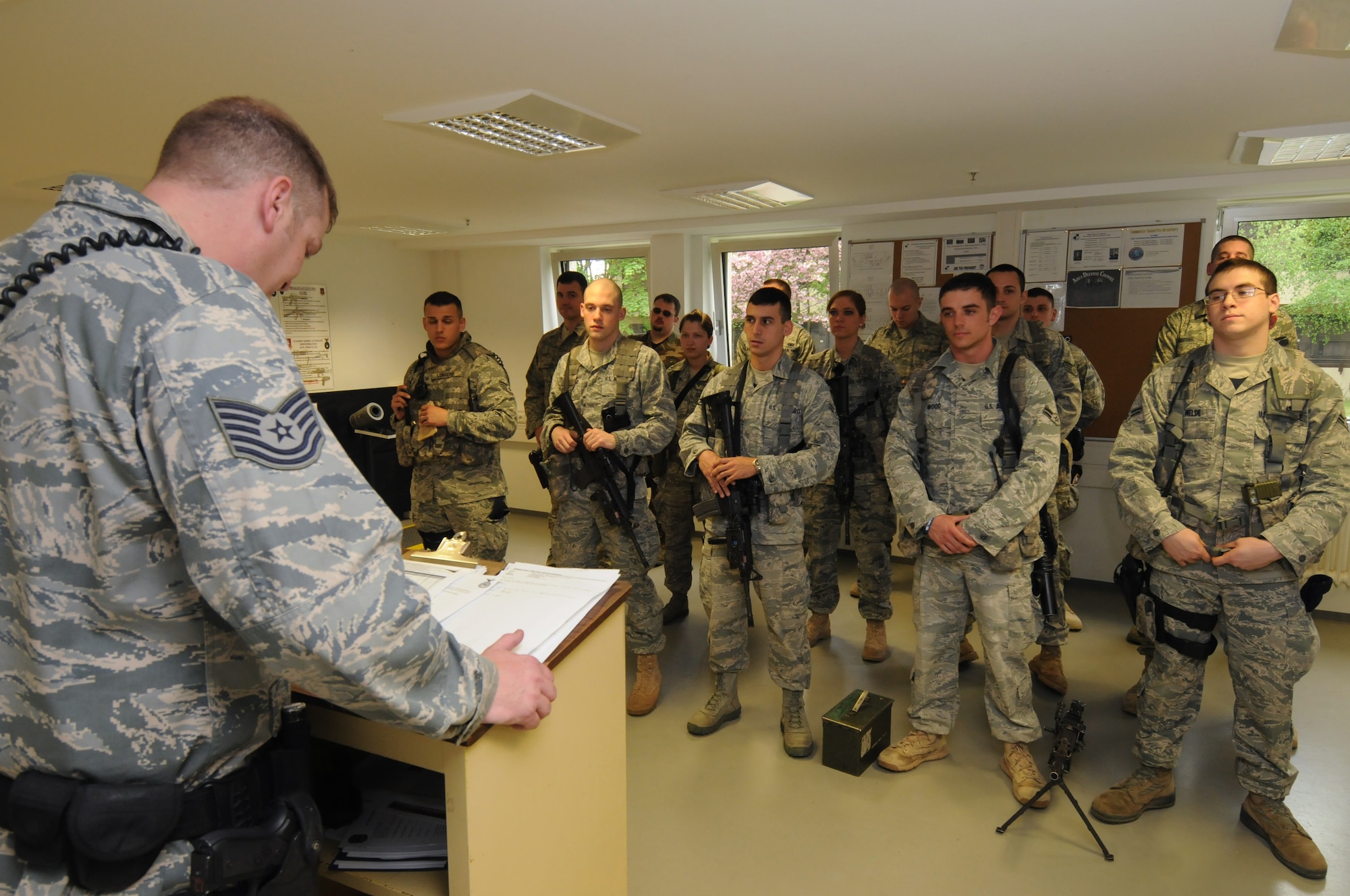 SPANGDAHLEM AIR BASE, Germany -- Tech. Sgt. Nick Hampton, 52nd Security Forces Squadron flight chief, briefs his flight during guard mount here April 21. Guard mount allows an opportunity for a flight chief to brief his Airmen about important squadron topics and the upcoming shift. (U.S. Air Force photo/Staff Sgt. Benjamin Wilson)