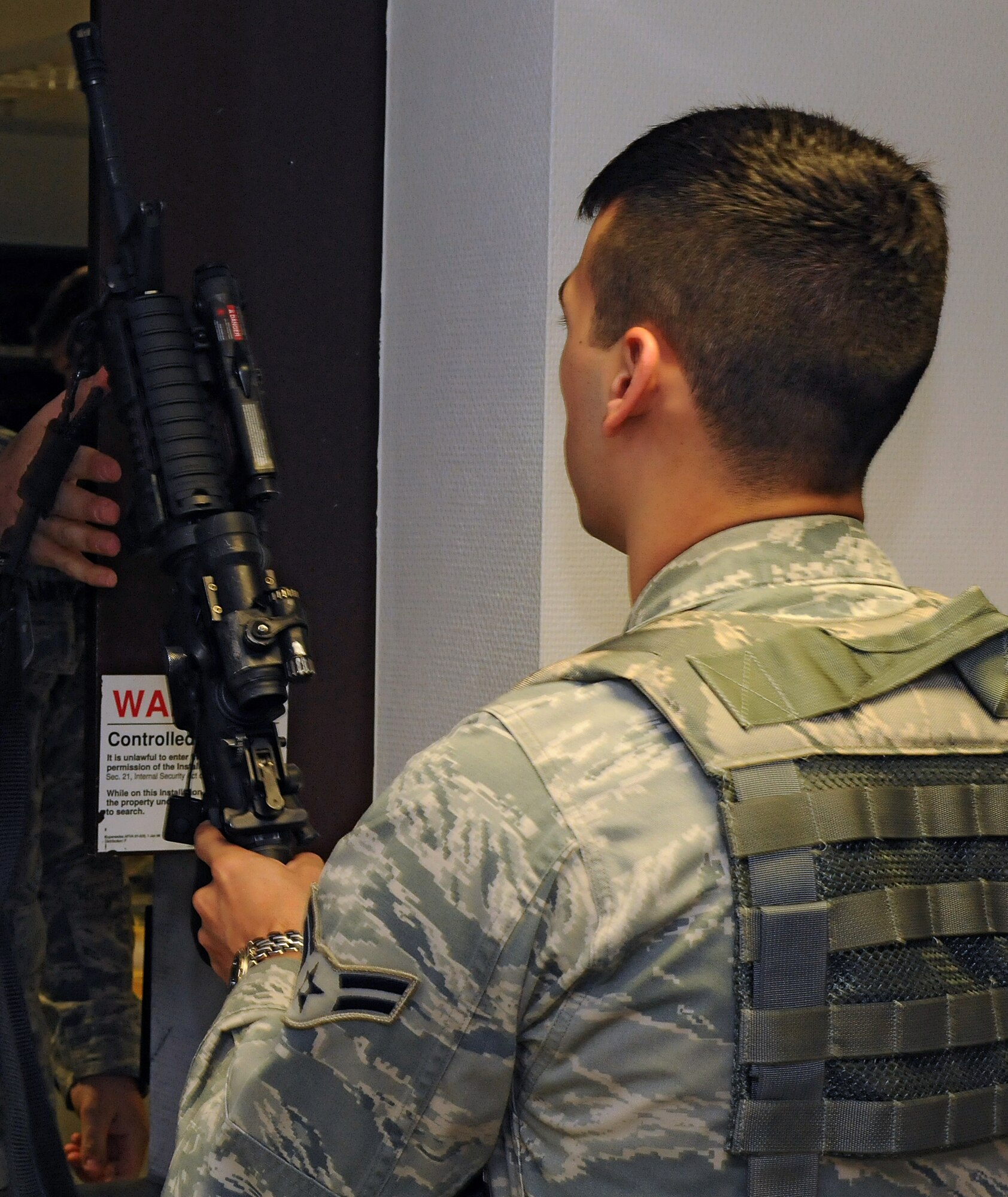 SPANGDAHLEM AIR BASE, Germany – Airman 1st Class Michael Maddox, 52nd Security Forces Squadron entry controller, checks out his weapon before guard mount here April 21. Guard mount allows an opportunity for a flight chief to brief his Airmen about important squadron topics and the upcoming shift. (U.S. Air Force photo/Staff Sgt. Benjamin Wilson)