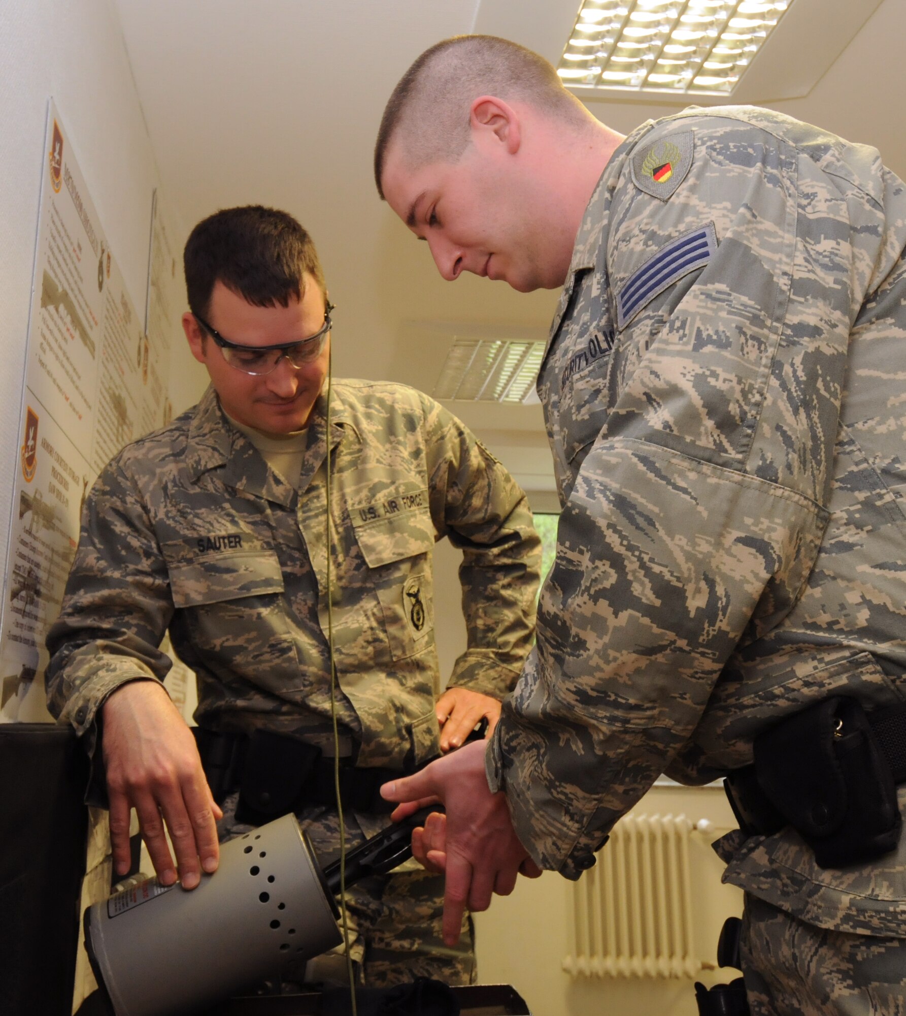 SPANGDAHLEM AIR BASE, Germany – Peter Beutler, 52nd Security Forces Squadron, clears his weapon as Staff Sgt. Tom Sauter, 52nd SFS desk sergeant, watches before receiving his briefing during guard mount here April 21. Guard mount allows an opportunity for a flight chief to brief his Airmen about important squadron topics and the upcoming shift. (U.S. Air Force photo/Staff Sgt. Benjamin Wilson)