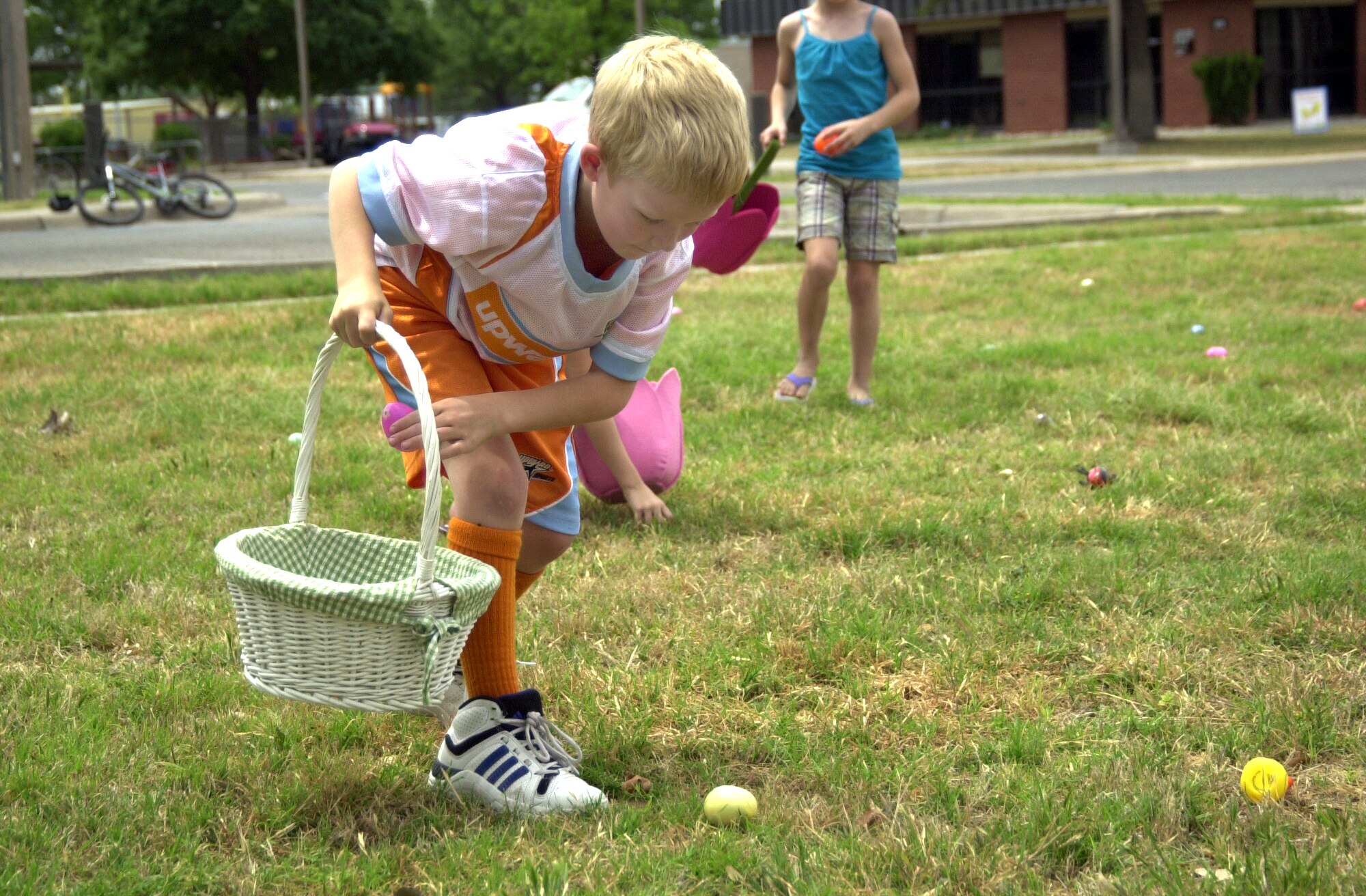 GOODFELLOW AIR FORCE BASE, Texas -- John Shirley, 7, fills his basket with eggs during the Annual Egg Hunt here April 23.  Hundreds of youths of all ages gathered at the Youth Complex in search of prize-filled eggs. (U.S. Air Force photo/Connie Hempel)