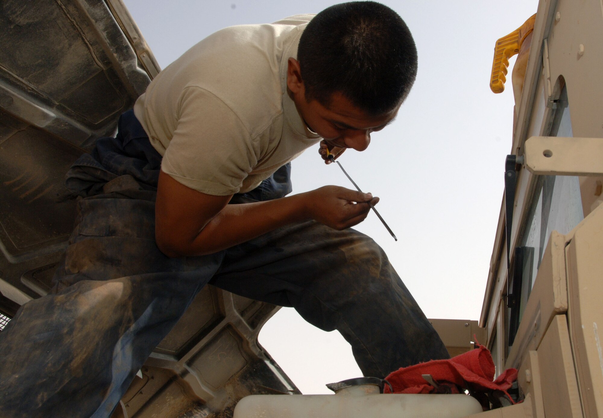 Senior Airman Greg Weiss, 532nd Expeditionary Operation Support Squadron Vehicle Maintenance Element mechanic and Lady Lake, Fla., native, checks the oil on a humvee April 18, 2011, at Al Asad Air Base, Iraq. The vehicle maintenance element is responsible for maintaining a 68 vehicle fleet worth more than $18 million. Airman Weiss is deployed from Eglin Air Force Base, Fla. (U.S. Air Force photo by Staff Sgt. R. Michael Longoria/Released)