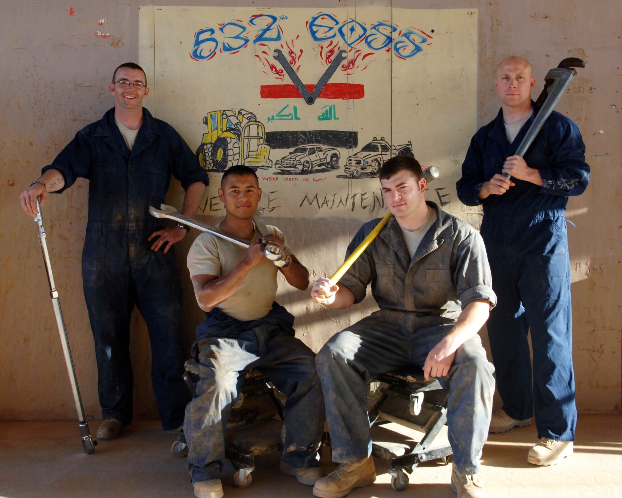 From left to right, Staff Sgt. Todd Hickman, Senior Airman Greg Weiss, Staff Sgt. Chris Stamm and Master Sgt. Brian Huffman pose for a photo April 23, 2011, at Al Asad Air Base, Iraq. The mechanics are assigned to the 532nd Expeditionary Operation Support Squadron Vehicle Maintenance Element, which is responsible for maintaining a 68 vehicle fleet worth more than $18 million. (U.S. Air Force photo by Staff Sgt. R. Michael Longoria/Released)