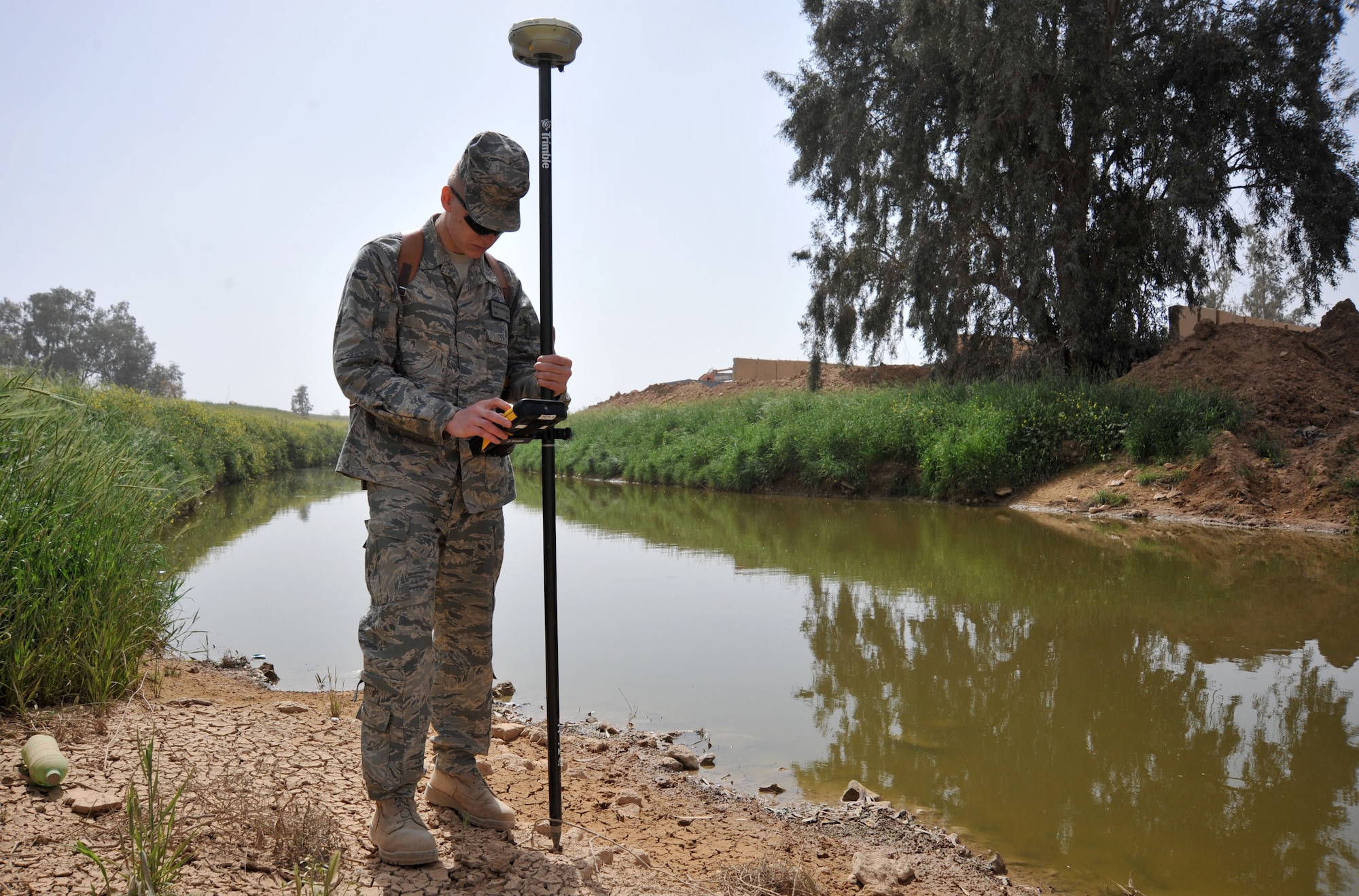 Senior Airman Yevgeniy Shatrovskiy, a Facilities Engineer Team engineering assistant, uses site surveying equipment April 13, 2011, at Contingency Operating Site Marez. The Marez team produces statements of work, plans and specifications for projects as well as surveying and mapping for several bases across northern Iraq. Airman Shatrovskiy is a Congers, N.Y., native deployed from Dover Air Force Base, Del. (U.S. Air Force photo by Senior Airman Andrew Lee/Released)
