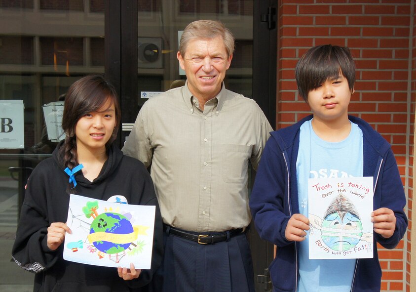 Hannah Kang (left) and Sung June DeAngelo (right) were the winners of the 2011 Earth Day poster contest. Of the 246 posters that were submitted, Hannah was the overall winner and her drawing was printed on the 2011 T-shirt.This year marks the 41st anniversary of Earth Day and Osan planted 10 trees and 200 flowers as part of the celebration. (Courtesy photo)