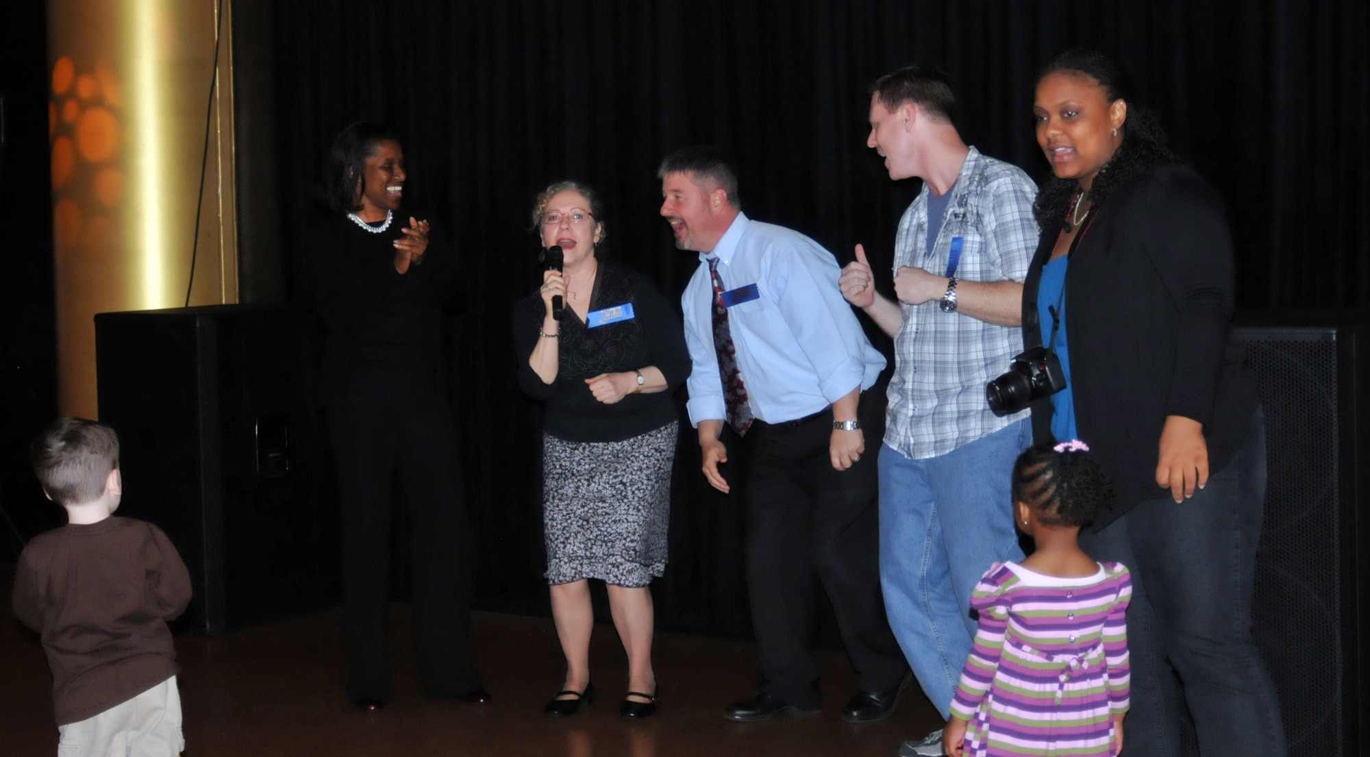 YOKOTA AIR BASE, Japan -- Family Advocacy staff members perform at the "Shake your booty not your baby" event held at the enlisted club, Yokota Air Base, Japan, April 22, 2011. The event, part of Child Abuse Prevention month, raised awareness of Shaken Baby Syndrome. (U.S. Air Force photo/Airman 1st Class Krystal M. Garrett)