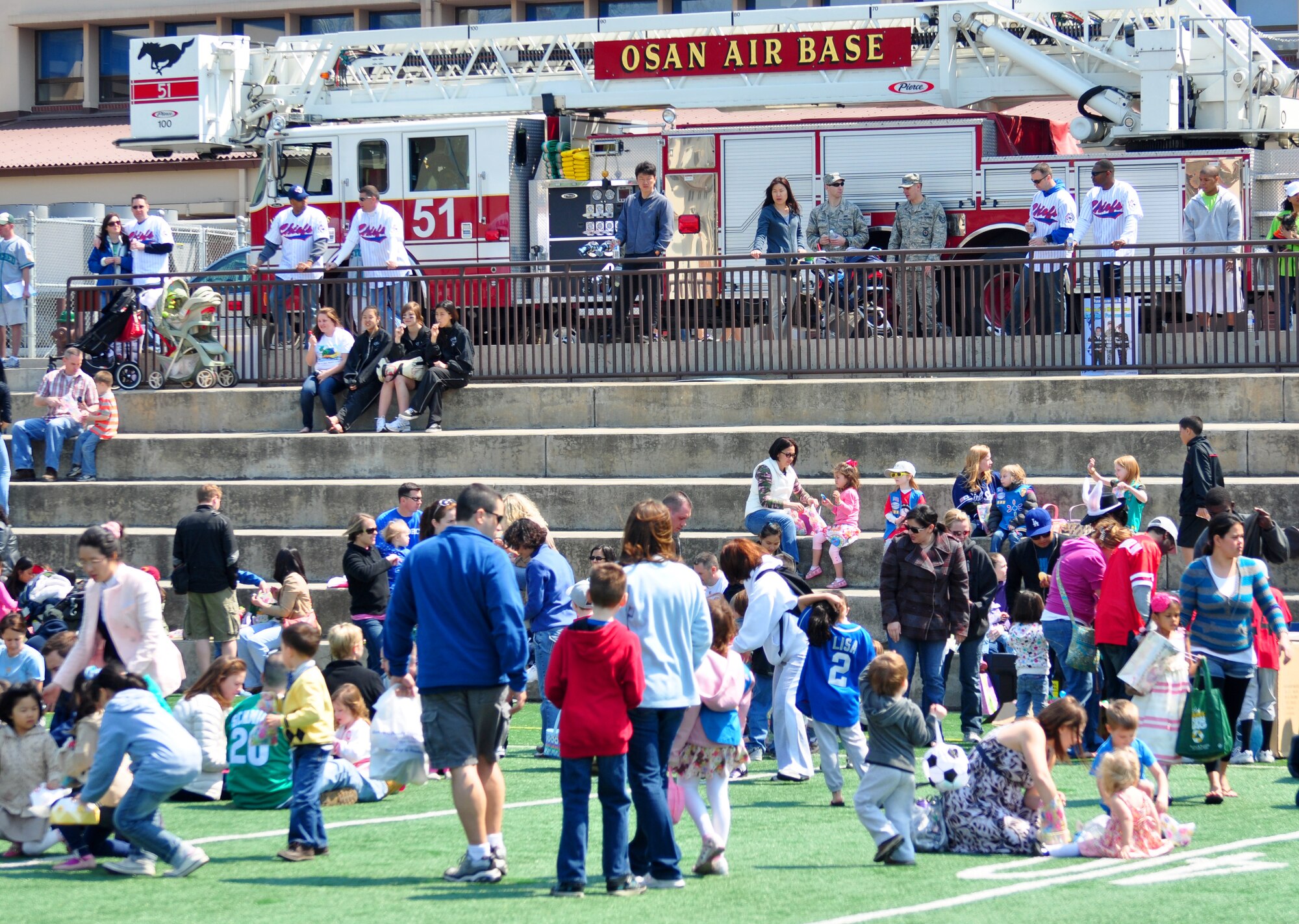 Osan celebrated Month of the Military Child and Child Abuse Prevention Month with a base parade and Easter egg hunt here April 23. About 200 people participated in the parade from the Officers' Club to the Osan High School football field. More than 10,000 plastic eggs were placed around the field for children to pick up during the Easter egg hunt. (U.S. Air Force photo/Staff Sgt. Chad Thompson)