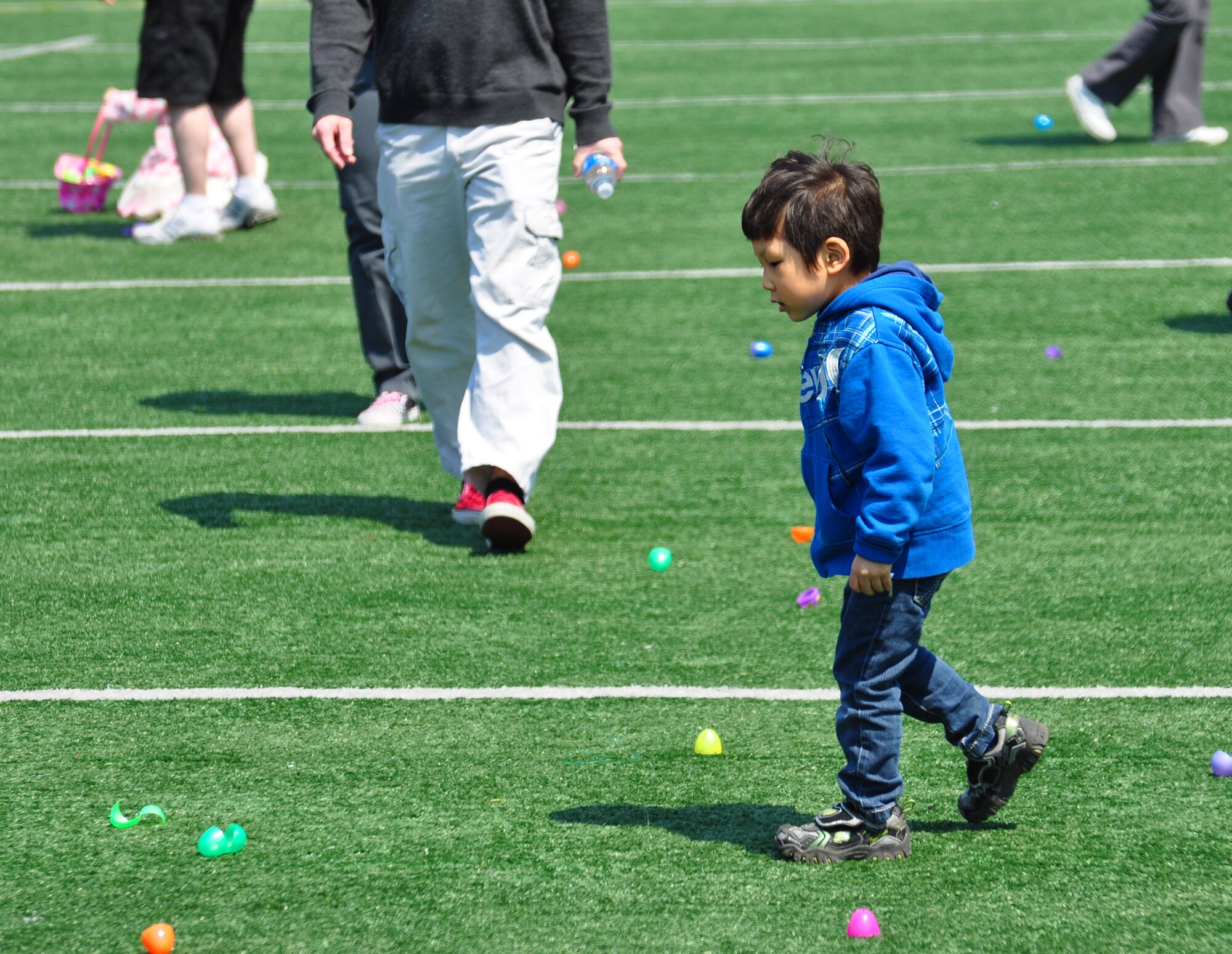 Osan celebrated Month of the Military Child and Child Abuse Prevention Month with a base parade and Easter egg hunt here April 23. About 200 people participated in the parade from the Officers' Club to the Osan High School football field. More than 10,000 plastic eggs were placed around the field for children to pick up during the Easter egg hunt. (U.S. Air Force photo/Staff Sgt. Chad Thompson)