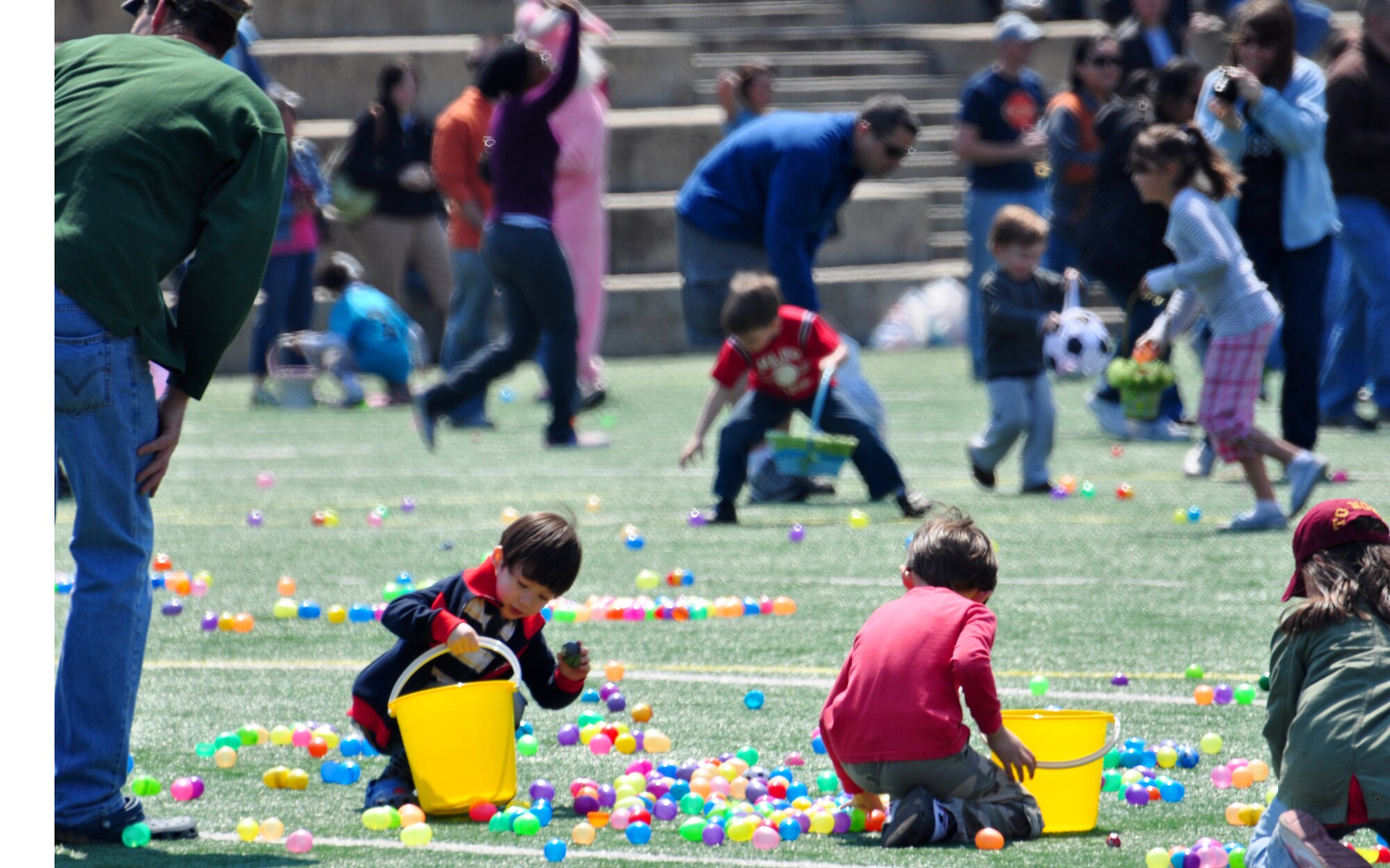 Osan celebrated Month of the Military Child and Child Abuse Prevention Month with a base parade and Easter egg hunt here April 23. About 200 people participated in the parade from the Officers' Club to the Osan High School football field. More than 10,000 plastic eggs were placed around the field for children to pick up during the Easter egg hunt. (U.S. Air Force photo/Staff Sgt. Chad Thompson)