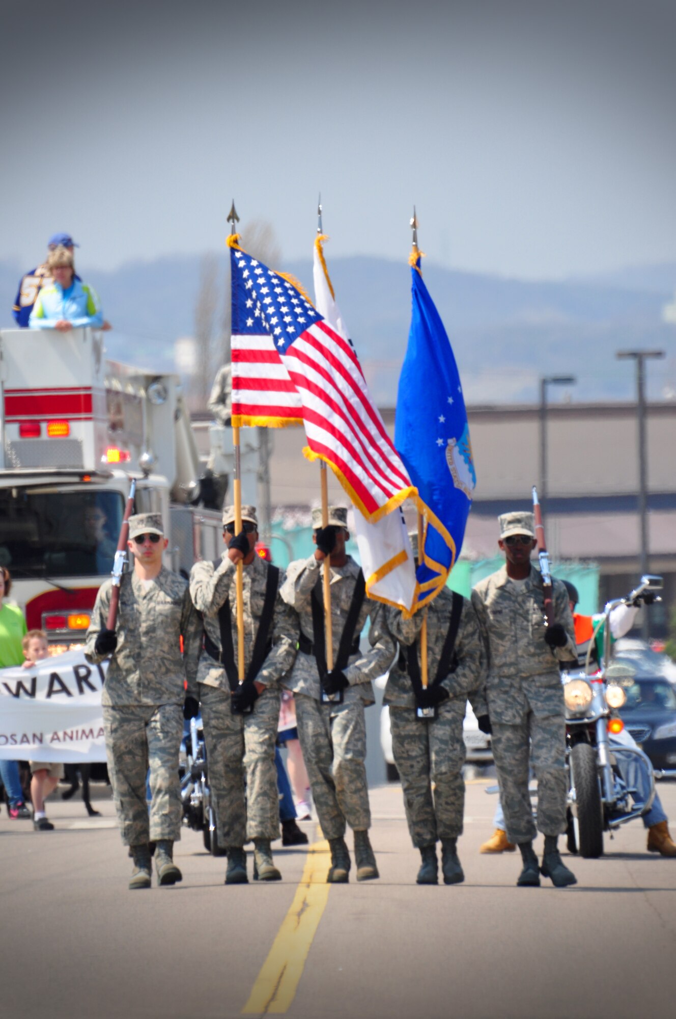 Osan's base honor guard members carry the colors in the parade from the Officers' Club to the Osan High School football field April 23. About 200 people participated in the parade celebrating Month of the Military Child and Child Abuse Prevention Month. (U.S. Air Force photo/Staff Sgt. Chad Thompson)