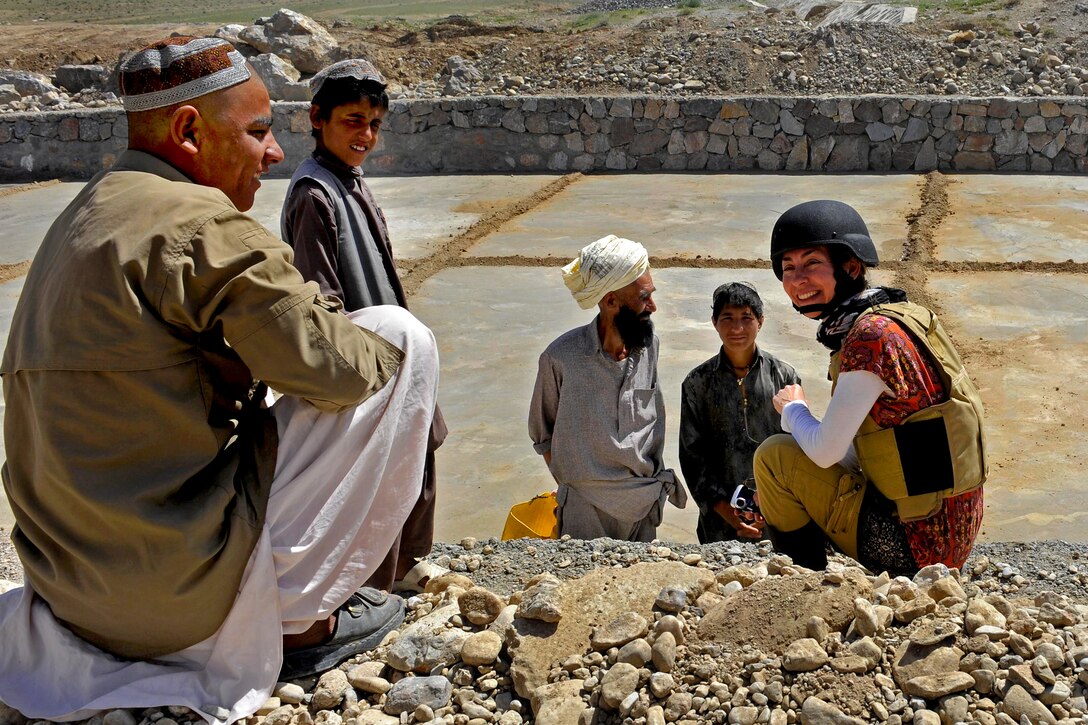 Laura Tedesco, right, an archeologist and cultural heritage program manager for the U.S. State Department in Afghanistan, talks with workers at an erosion control project on Highway 1 in Afghanistan's Zabul province, April 23, 2011.