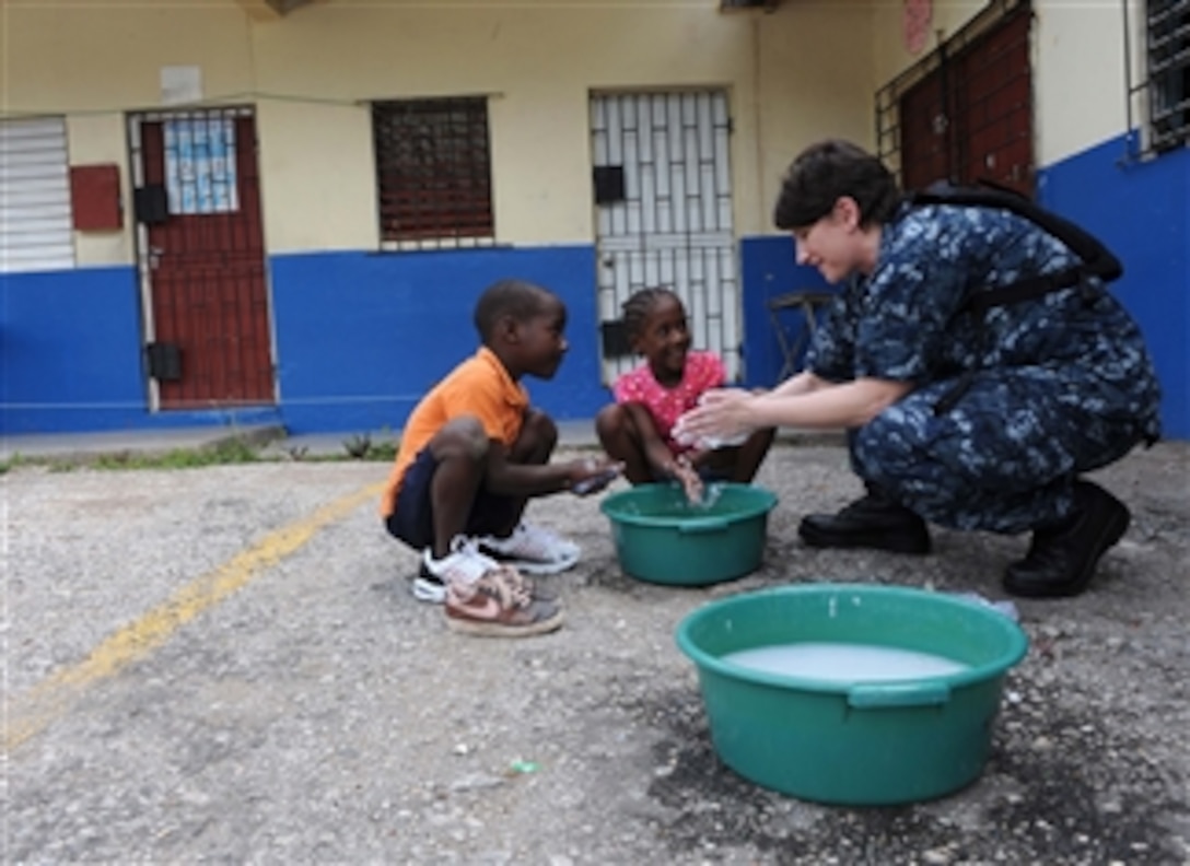 Lt. Danna Convoy teaches children how to properly wash their hands during a Continuing Promise community service event in Kingston, Jamaica, on April 21, 2011.  Continuing Promise is a five-month humanitarian assistance mission to the Caribbean, Central and South America.  