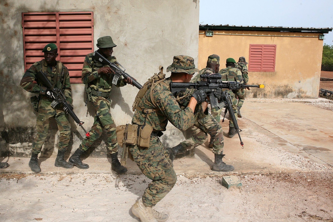 Sgt. Austin Sabin maneuvers a fire team of Senegalese commandos through a final military operation in urban terrain exercise at the end of a three week partnered evolution here, recently. The partnership was an Africa Partnership Station 2011 initiative, in which the Marines of second platoon, Ground Combat Element, Security Cooperation Task Force, APS-11 exchanged concepts and cultures with Senegalese Commandos.