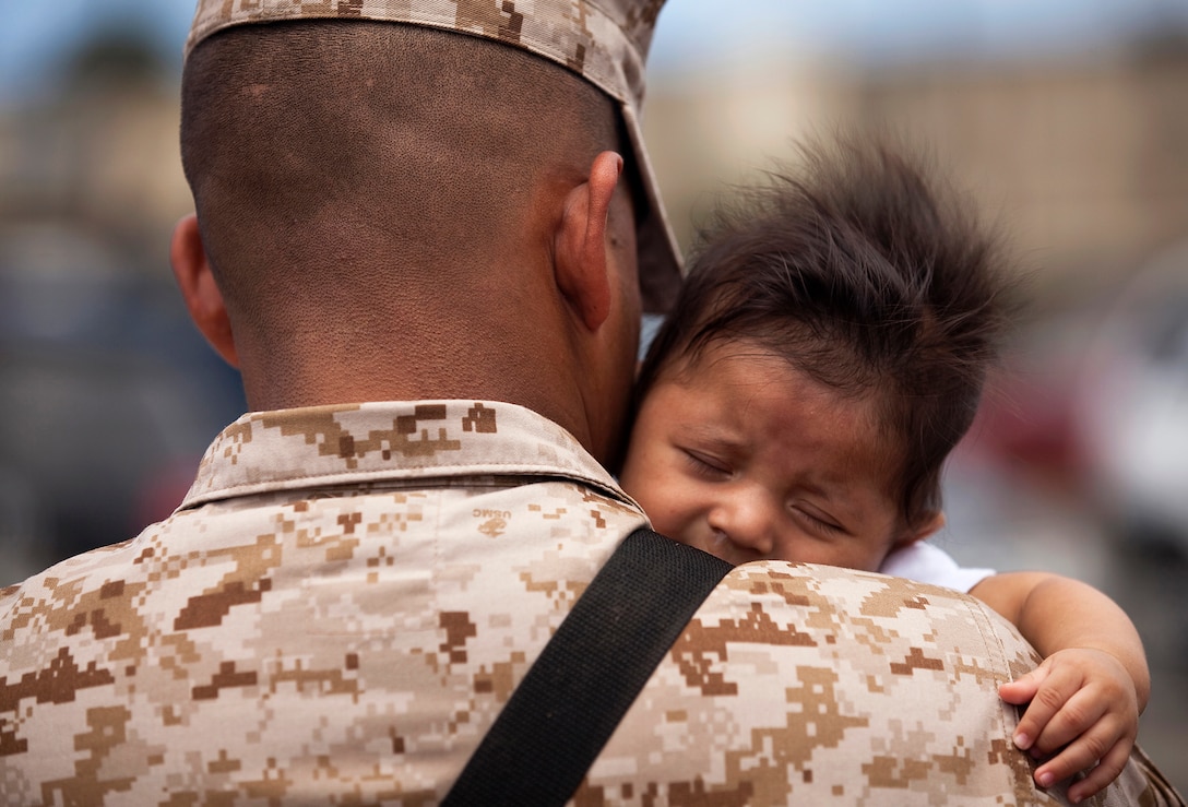 Cpl. Antonio Tellez, an administrative clerk with Headquarters Battery, 1st Battalion, 12th Marine Regiment, holds his 3-month-old son before departing Marine Corps Base Hawaii on a seven-month deployment to Afghanistan in support of Operation Enduring Freedom, April 25, 2011. Over the course of the week, approximately 550 Marine and sailors from 1/12 departed Hawaii to replace 1st Battalion, 10th Marine Regiment, in Afghanistan’s Helmand province. Unlike their last two deployments — supporting Task Forces Military Police in Iraq — 1/12 will revert back to its primary mission and provide artillery fire support to 2nd Marine Division (Forward) during ongoing counterinsurgency operations in the province.