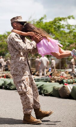 Sgt. Juan Gutierrez, assistant wire chief for Headquarters Battery, 1st Battalion, 12th Marine Regiment, enjoys some time with his 4-year-old daughter before departing Marine Corps Base Hawaii on a seven-month deployment to Afghanistan in support of Operation Enduring Freedom, April 25, 2011. Over the course of the week, approximately 550 Marine and sailors from 1/12 left Hawaii to replace 1st Battalion, 10th Marine Regiment, in Afghanistan’s Helmand province. Unlike their last two deployments — supporting Task Forces Military Police in Iraq — 1/12 will revert back to its primary mission and provide artillery fire support to 2nd Marine Division (Forward) during ongoing counterinsurgency operations in the province.