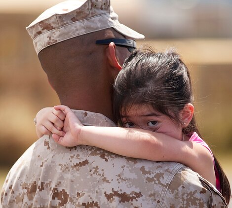 The 3-year-old daughter of Petty Officer 2nd Class Jerome Cinco, a hospital corpsman with Headquarters Battery, 1st Battalion, 12th Marine Regiment, holds her father close before his departure from Marine Corps Base Hawaii on a seven-month deployment to Afghanistan, April 25, 2011. Over the course of the week, approximately 550 Marine and sailors from 1/12 left Hawaii to replace 1st Battalion, 10th Marine Regiment, in Afghanistan’s Helmand province in support of Operation Enduring Freedom. Unlike their last two deployments — supporting Task Forces Military Police in Iraq — 1/12 will revert back to its primary mission and provide artillery fire support to 2nd Marine Division (Forward) during ongoing counterinsurgency operations in the province.