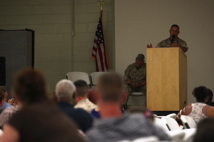 Col. Daniel Lecce, commanding officer of Marine Corps Base Camp Lejeune, flanked by Lt. Gen. John Paxton, commanding general of II Marine Expeditionary Force, speaks to and answers the questions of Tarawa Terrace families at a town hall meeting at the recreation center aboard the housing community, April 26. A week and a half after the destruction of the tornado that ripped through TT and the surrounding Jacksonville area, this meeting informed the affected residents of financial and donation aid options available to the through base and town facets.