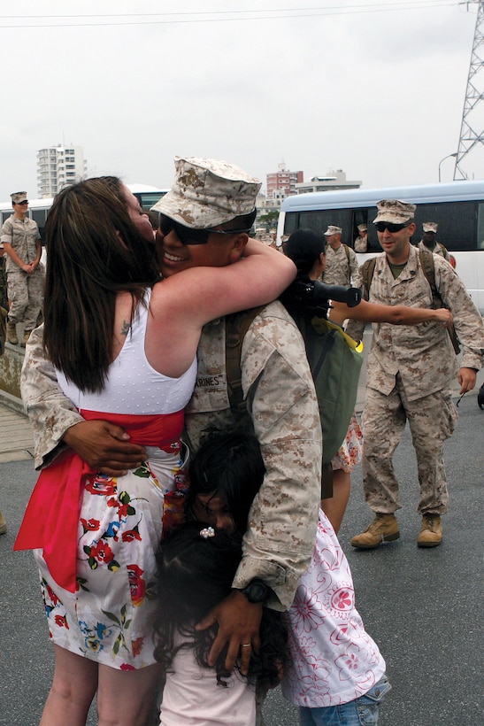 Sgt. Robert Torres, a military policeman with Combat Logistics Battalion 3, Combat Logistics Regiment 3, 3rd Marine Logistics Group, III Marine Expeditionary Force, embraces his wife, Rose Marie Torres, and daughters Brooklyn and Haven, after returning from Afghanistan April 26.