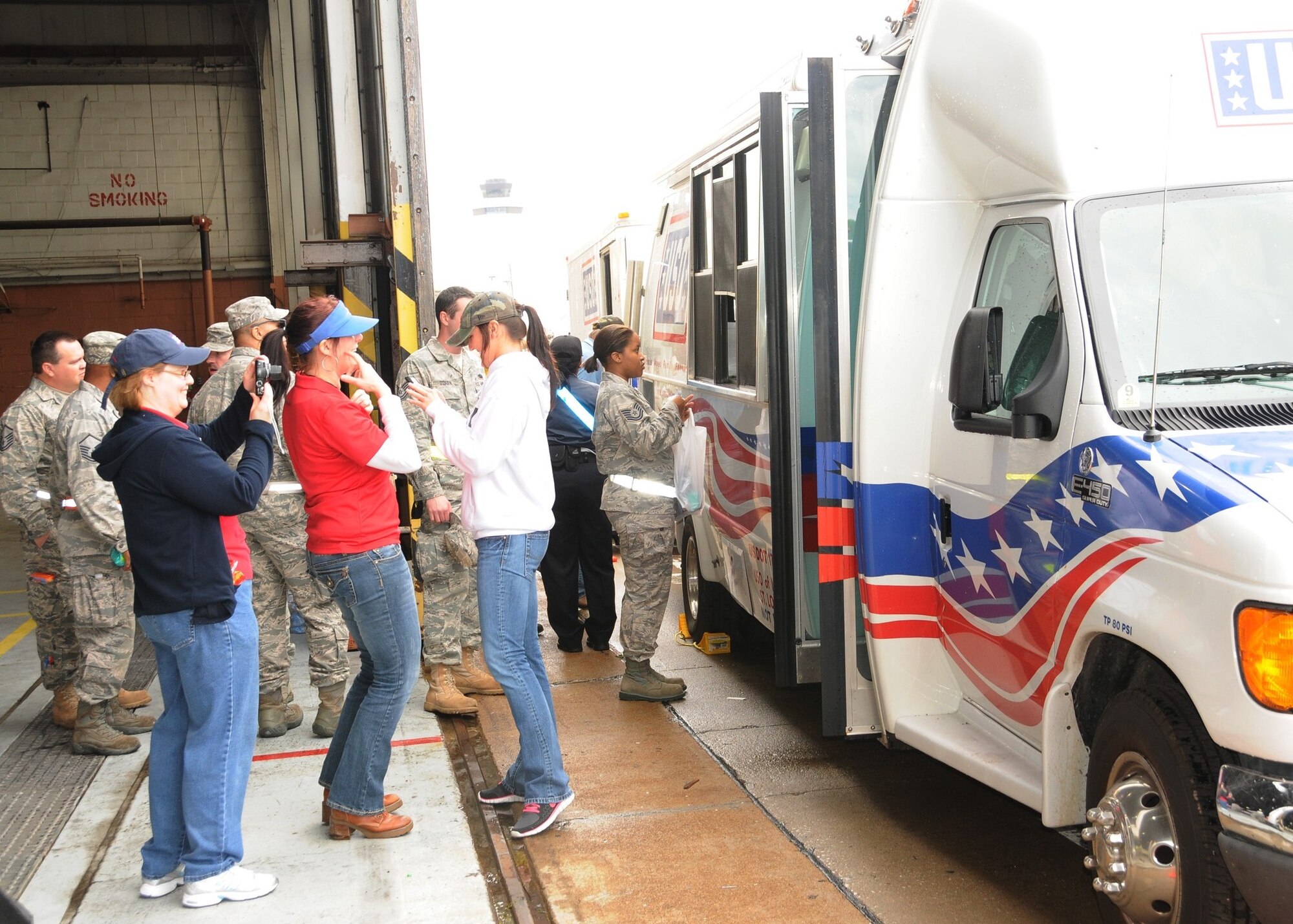 Members of the 131st Bomb Wing enjoy a welcome lunch break courtesy of the mobile kitchen of the USO at Lambert Field, April 26. A category EF4 tornado hit Lambert-Saint Louis International Airport and swept across the 131st Bomb Wing Missouri Air National Guard Base, April 22. No injuries were reported to Air National Guard personnel, but there was widespread damage across the south-side of the base. Estimates for repair to the base could top 10 million U.S. dollars.  Cleanup efforts at the base are ongoing. (Photo by Master Sgt. Mary-Dale Amison)