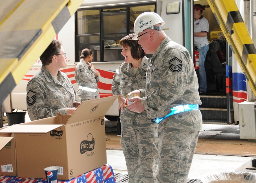 Members of the 131st Bomb Wing enjoy a welcome lunch break courtesy of the mobile kitchen of the USO at Lambert Field, April 26. A category EF4 tornado hit Lambert-Saint Louis International Airport and swept across the 131st Bomb Wing Missouri Air National Guard Base, April 22. No injuries were reported to Air National Guard personnel, but there was widespread damage across the south-side of the base. Estimates for repair to the base could top 10 million U.S. dollars.  Cleanup efforts at the base are ongoing. (Photo by Master Sgt. Mary-Dale Amison)