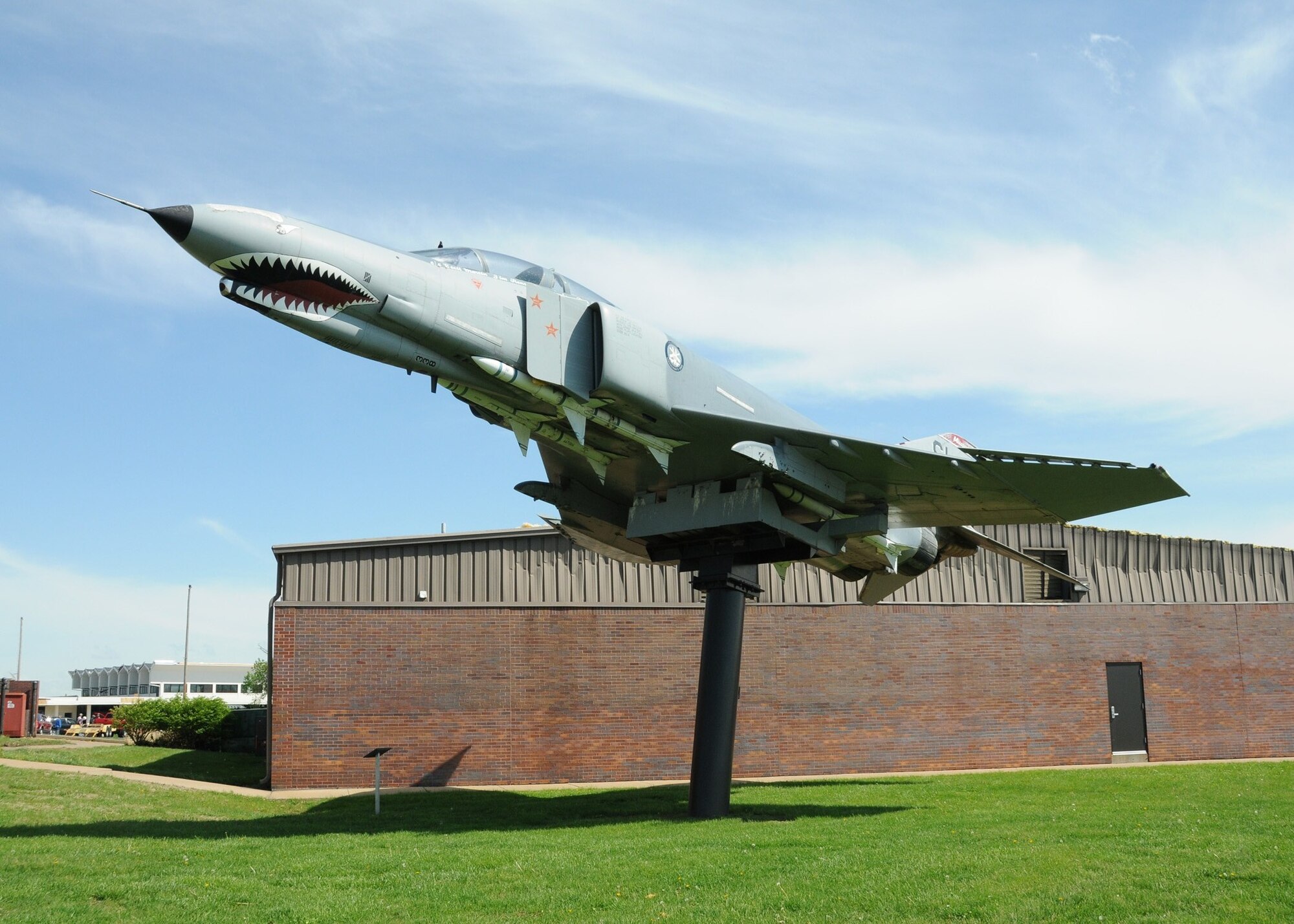 An F-4E Phantom II Legacy aircraft from the era when the 131st Bomb Wing was designated the 131st Tactical Fighter Wing, continues to “soar” proudly, April 26, just days after a category EF4 tornado swept across the Lambert-Saint Louis Air National Guard Base, April 22. No injuries were reported to Air National Guard personnel, but there was widespread damage across the south-side of the base. Estimates for repair to the base could top 10 million U.S. dollars.  Cleanup efforts at the base are  ongoing. (Photo by Master Sgt. Mary-Dale Amison)