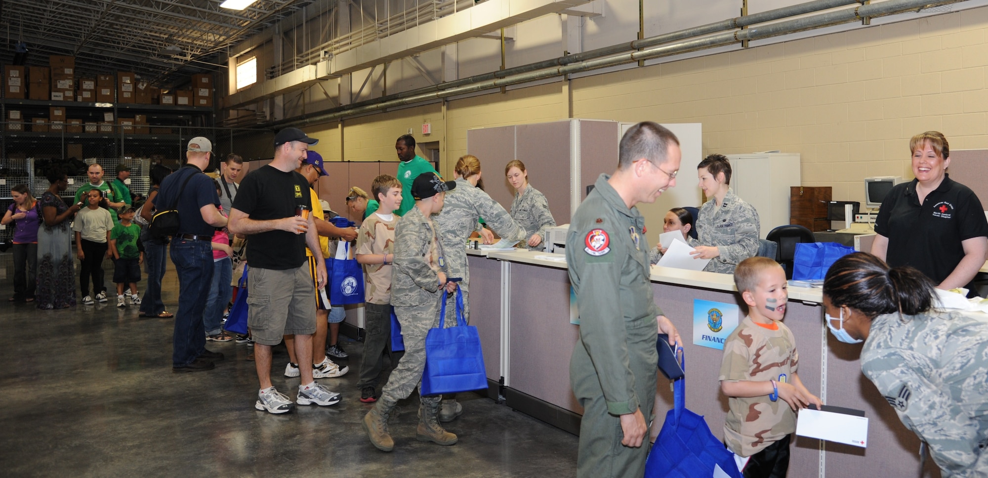 Children are issued dog tags, get warrior paint on their faces, get a quick dental check up and more as they go through a deployment line at the annual Operation KIDS event, April 23. The goal for the event is to help children in military families understand and experience the processes their parents go through during deployments. (U.S. Air Force Photo/Airman 1st Class Adawn Kelsey)
